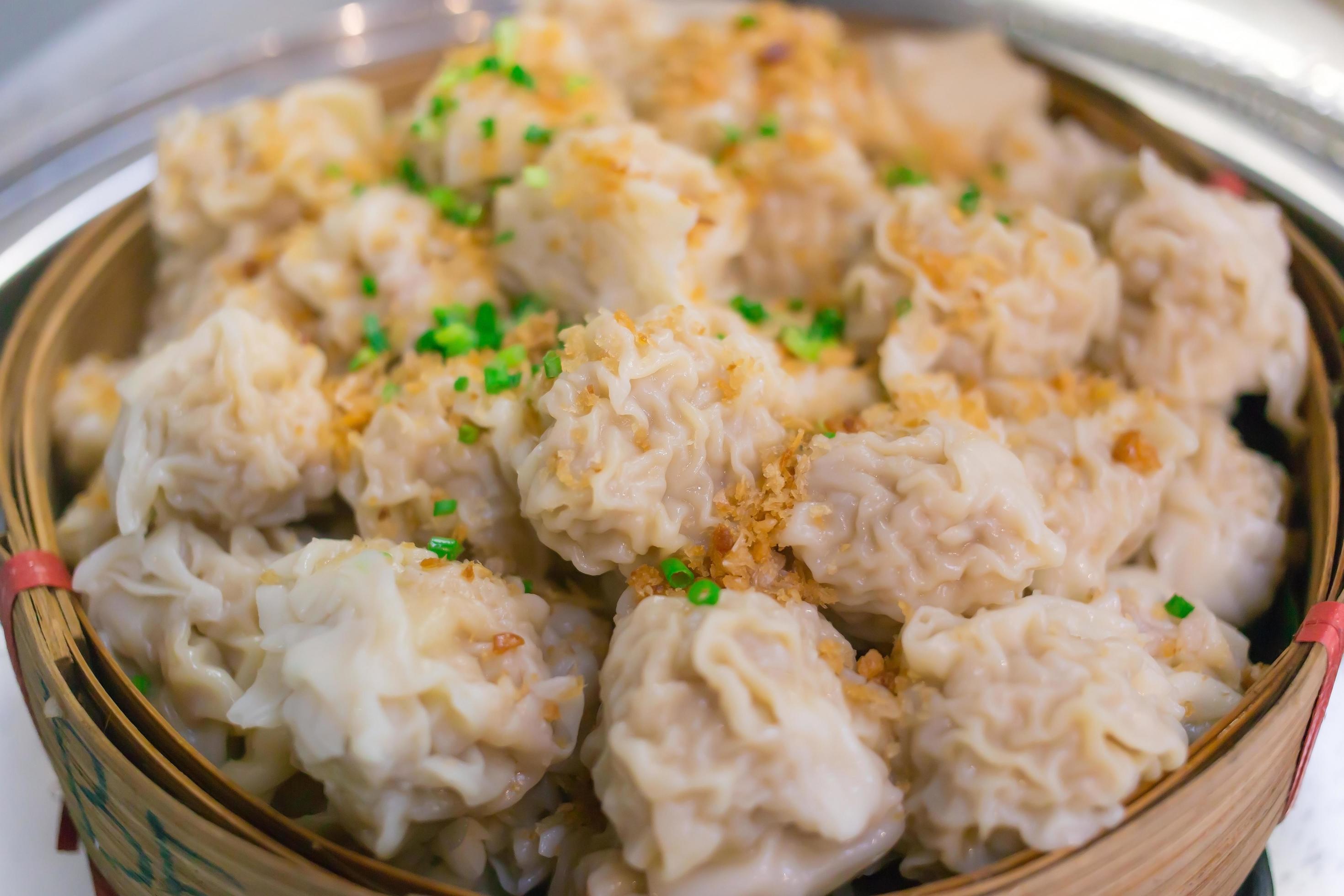 Shaomai is a Chinese food which it made from pork on top with fried garlic and chopped spring onion put on bamboo basket. Stock Free