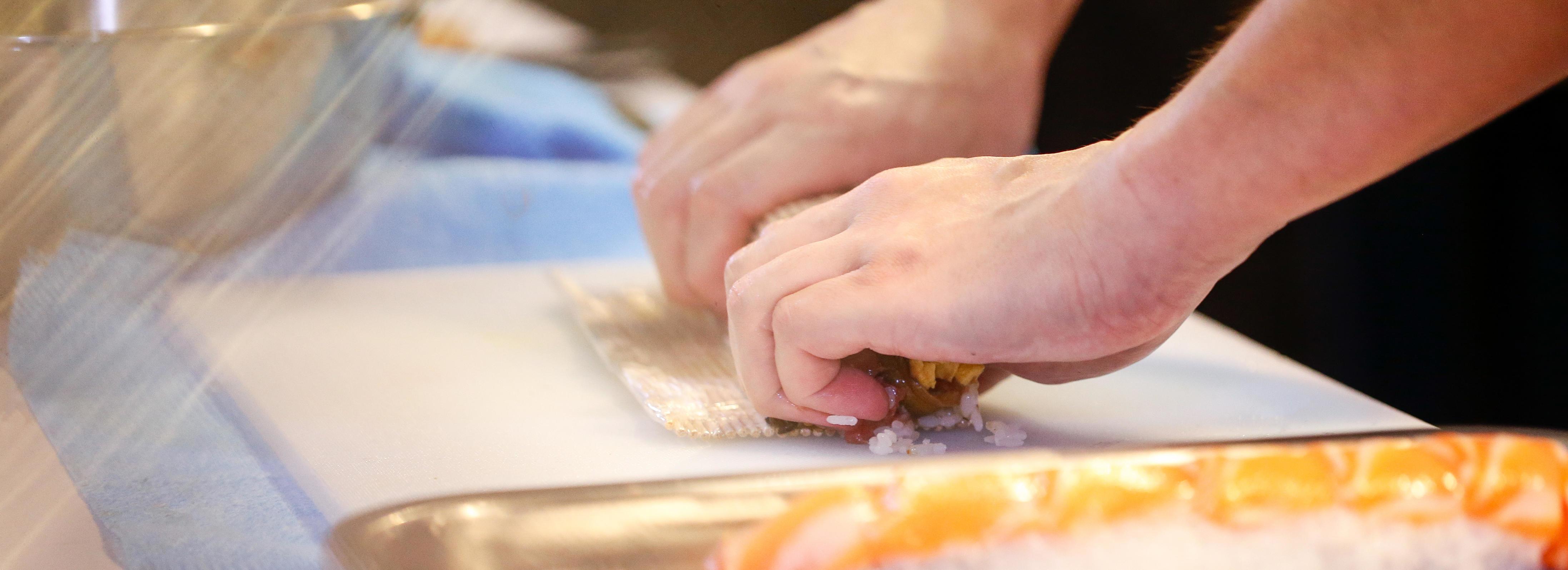 chef hands preparing japanese food, chef making sushi Stock Free