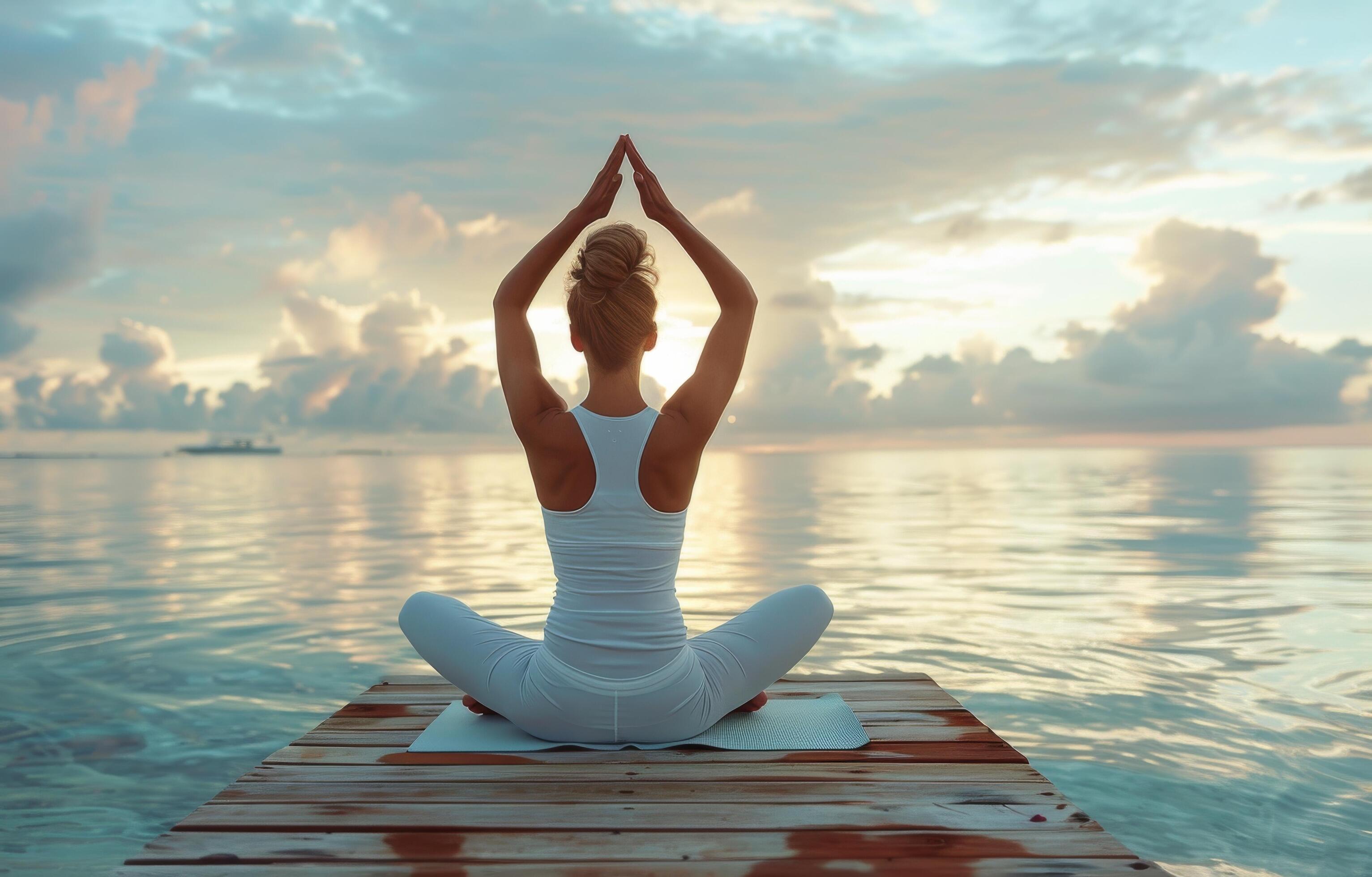 Woman Practicing Yoga on Wooden Dock During Sunrise at the Beach Stock Free