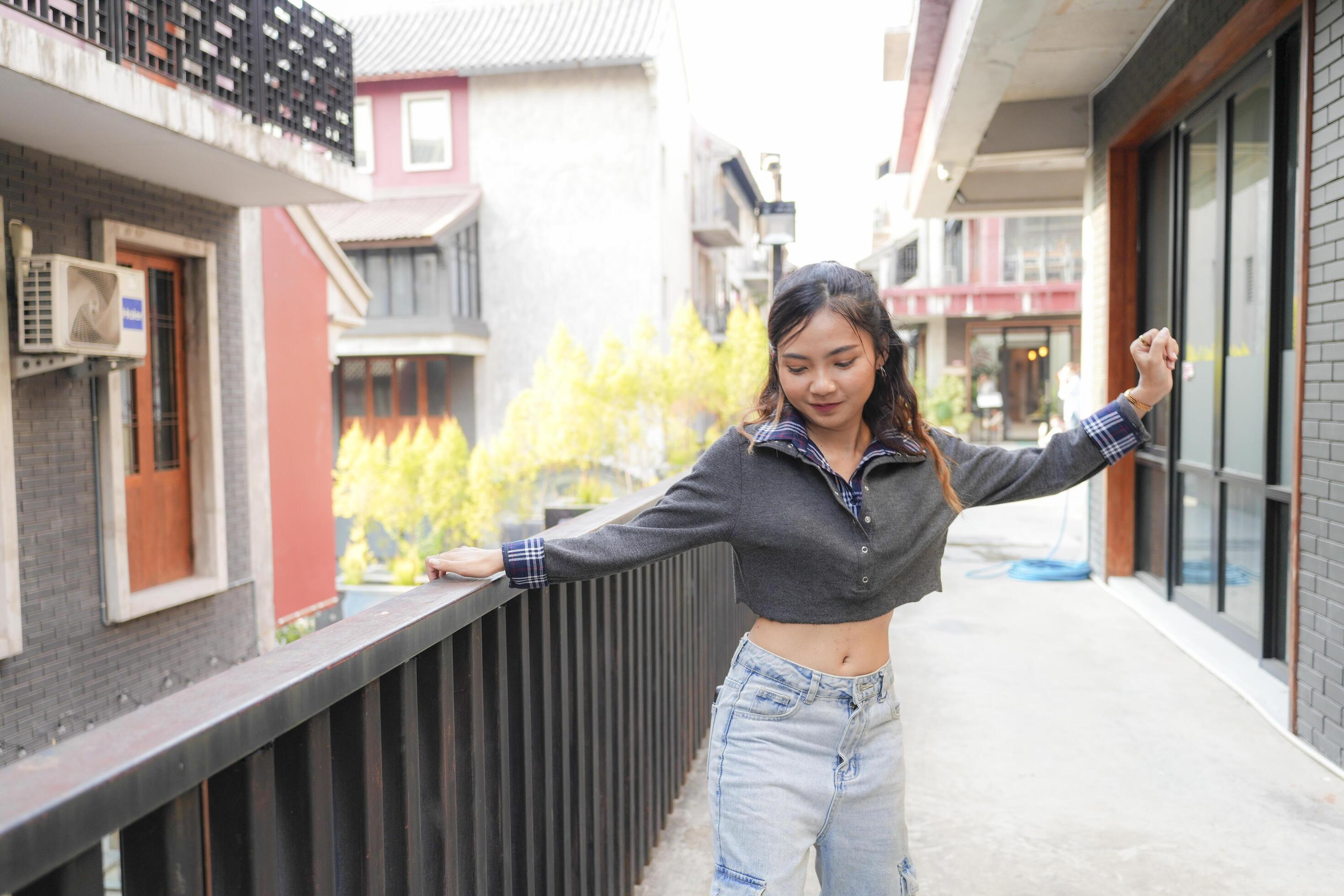 Asian women do freestyle hip hop and breakdancing in a public space in the middle of the city. With a cheerful and happy attitude Stock Free