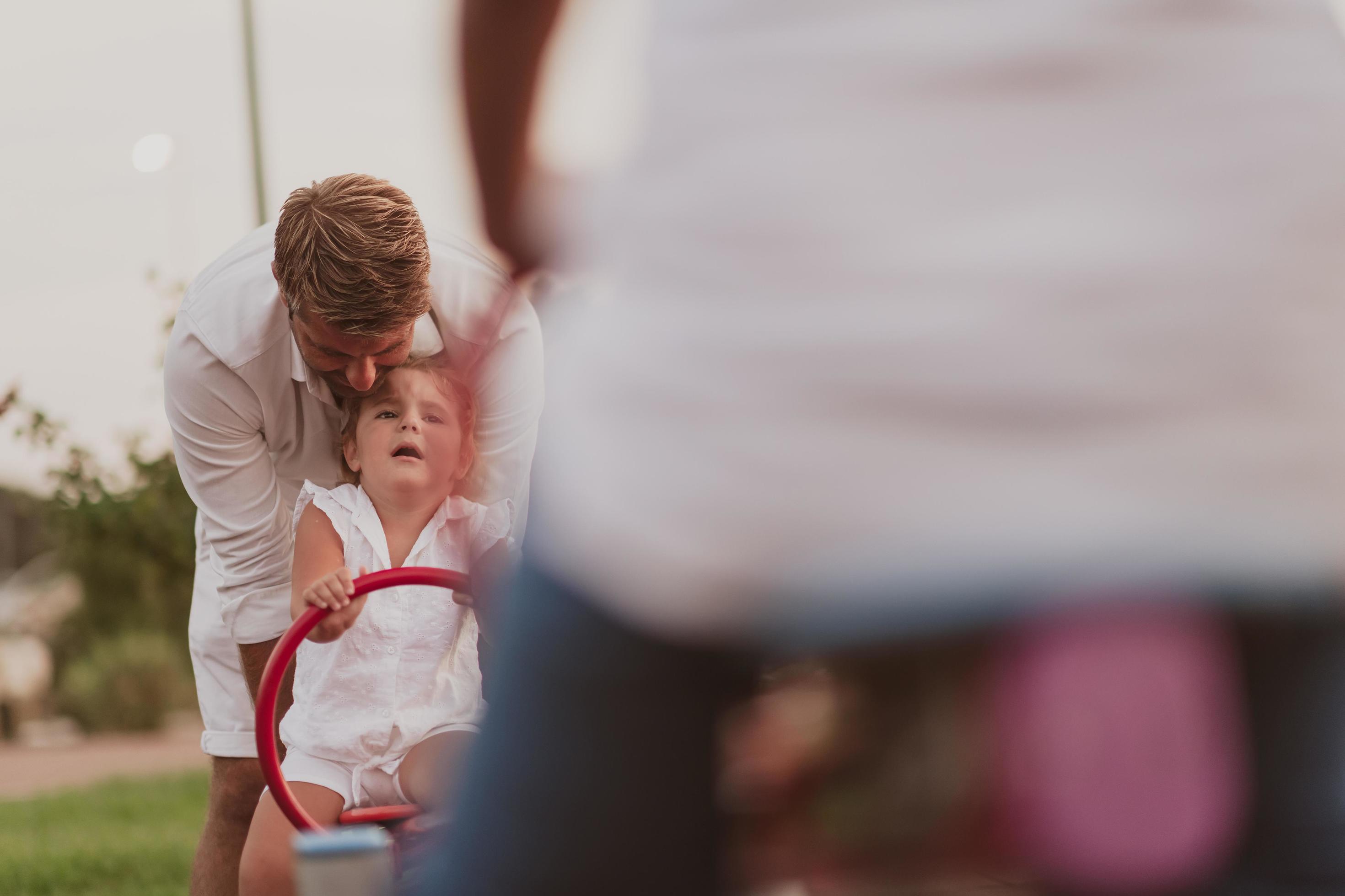 An elderly man in casual clothes with his daughter spends time together in the park on vacation. Family time. Selective focus Stock Free