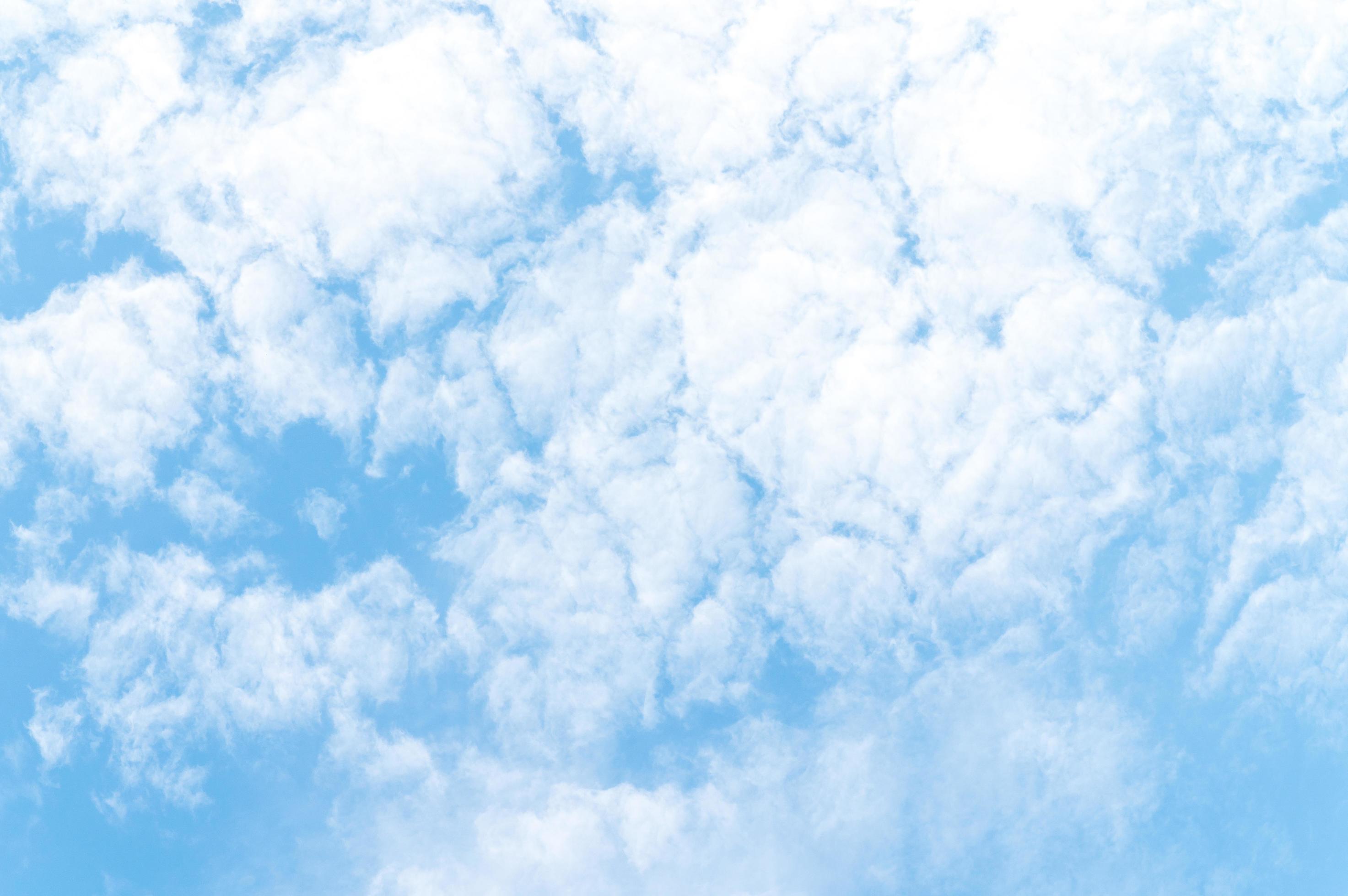 Nature background from white clouds in sunny day. Beautiful white fluffy clouds in blue sky. Stock Free