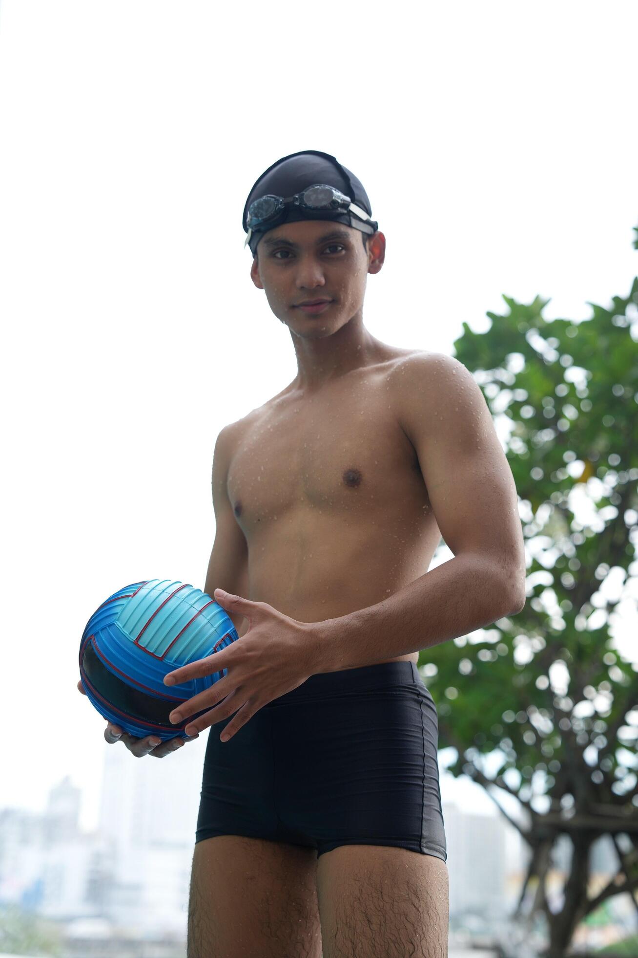 Asian men practicing swimming and preparing to play water polo and stretching and resting for water sports. Stock Free