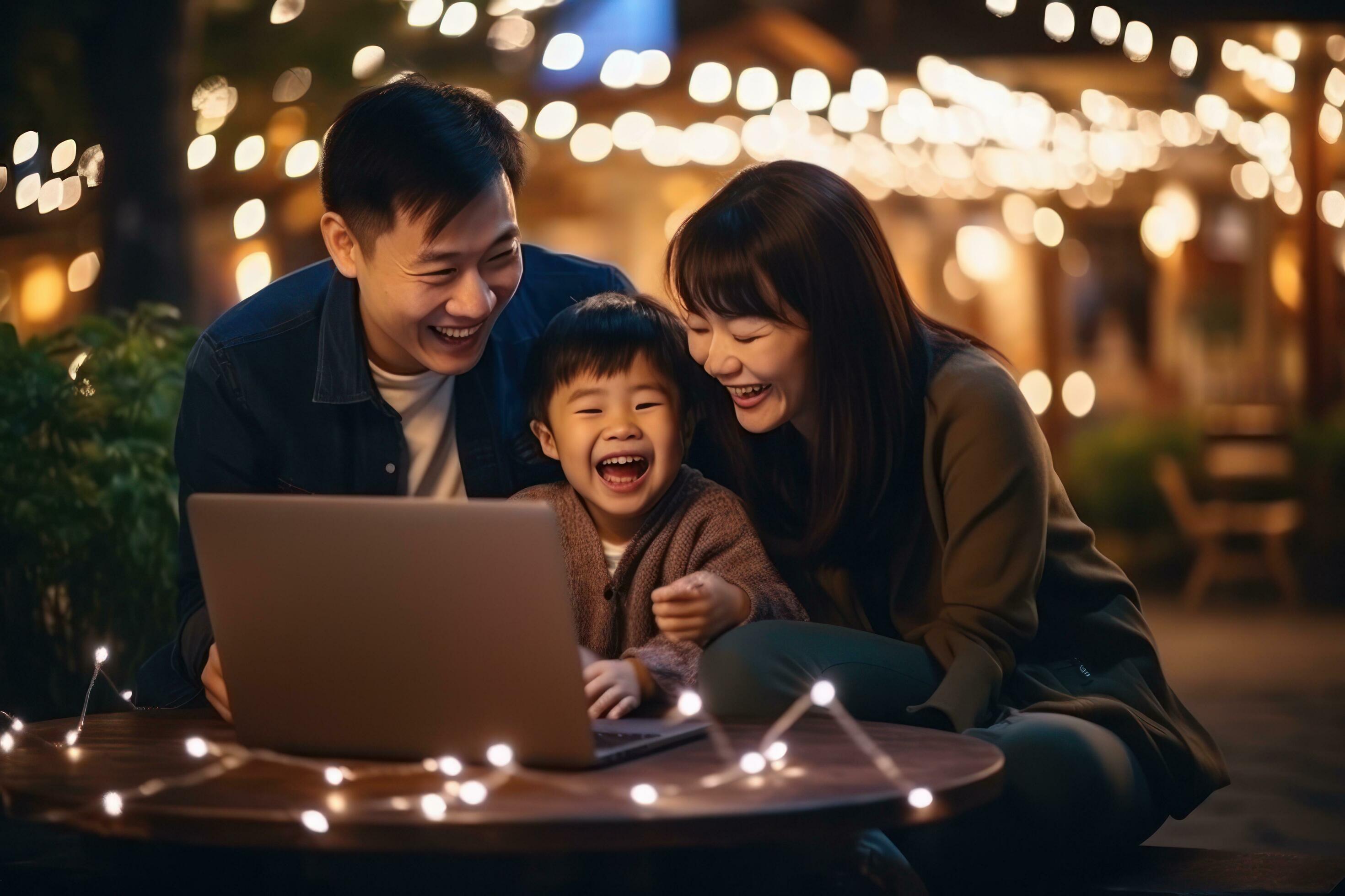 Family is looking at a laptop while sitting on a sofa Stock Free