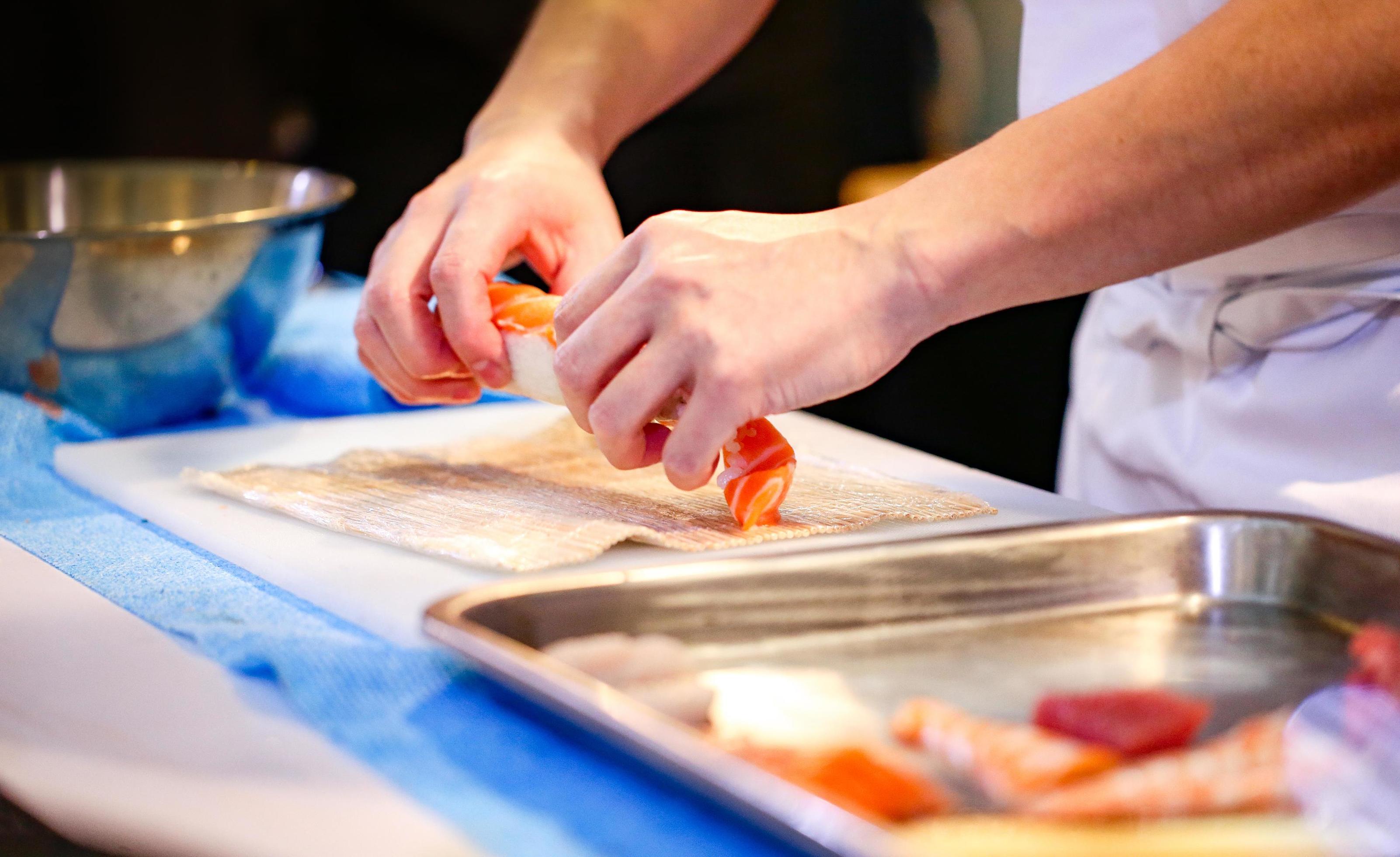 chef hands preparing japanese food, chef making sushi Stock Free