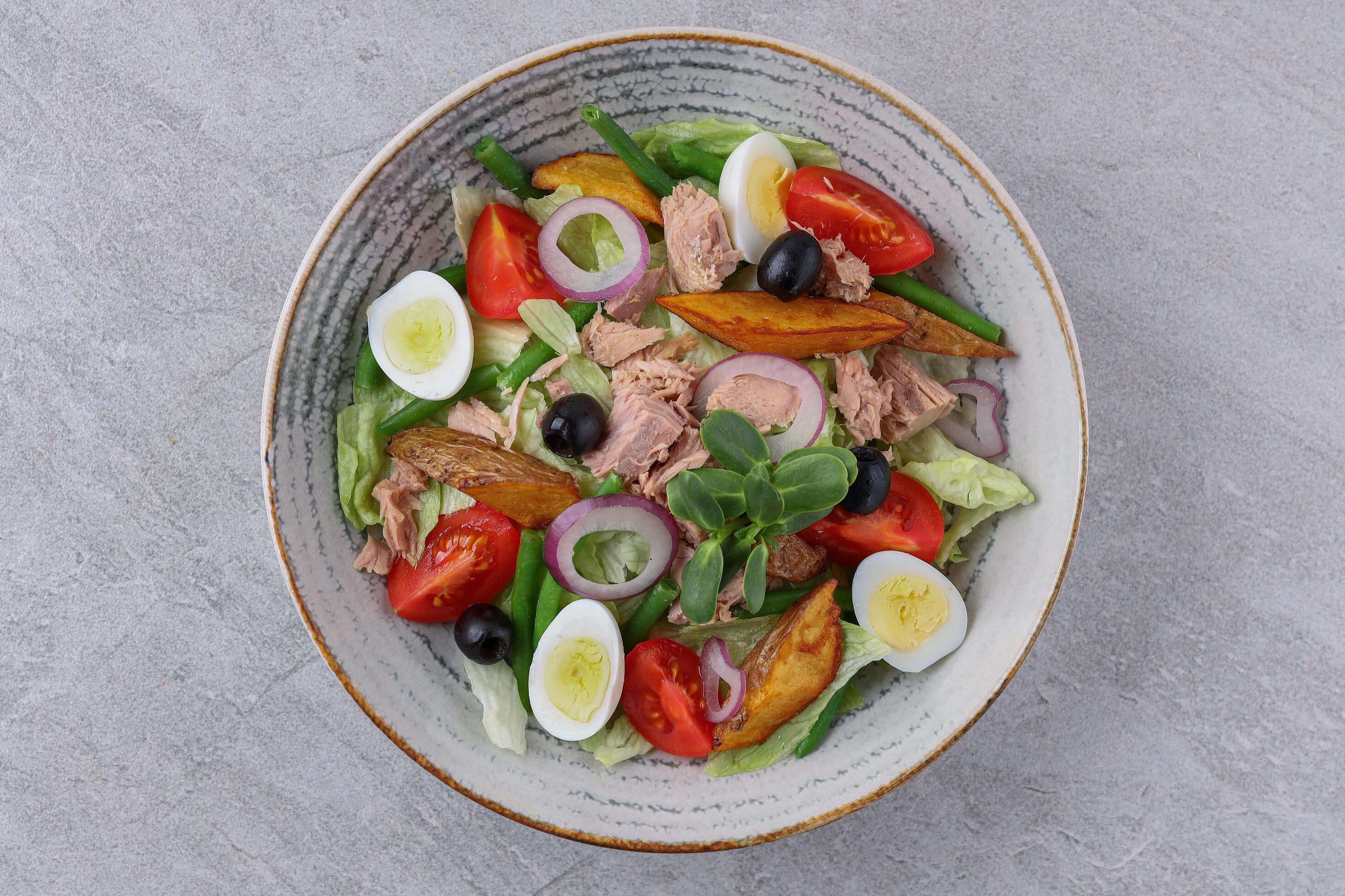 salad with tuna, quail eggs and baked potatoes on a stone background, studio food photography 2 Stock Free