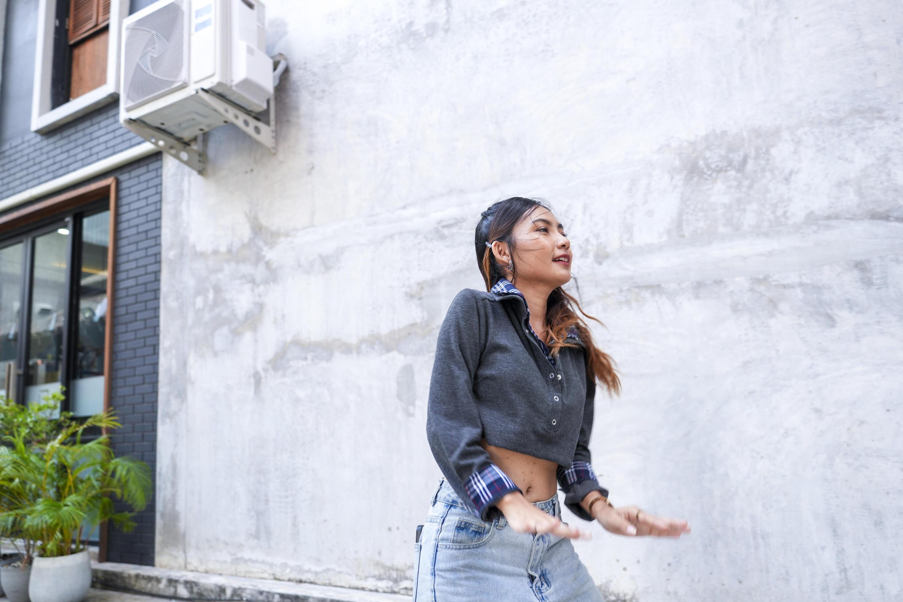 Asian women do freestyle hip hop and breakdancing in a public space in the middle of the city. With a cheerful and happy attitude Stock Free