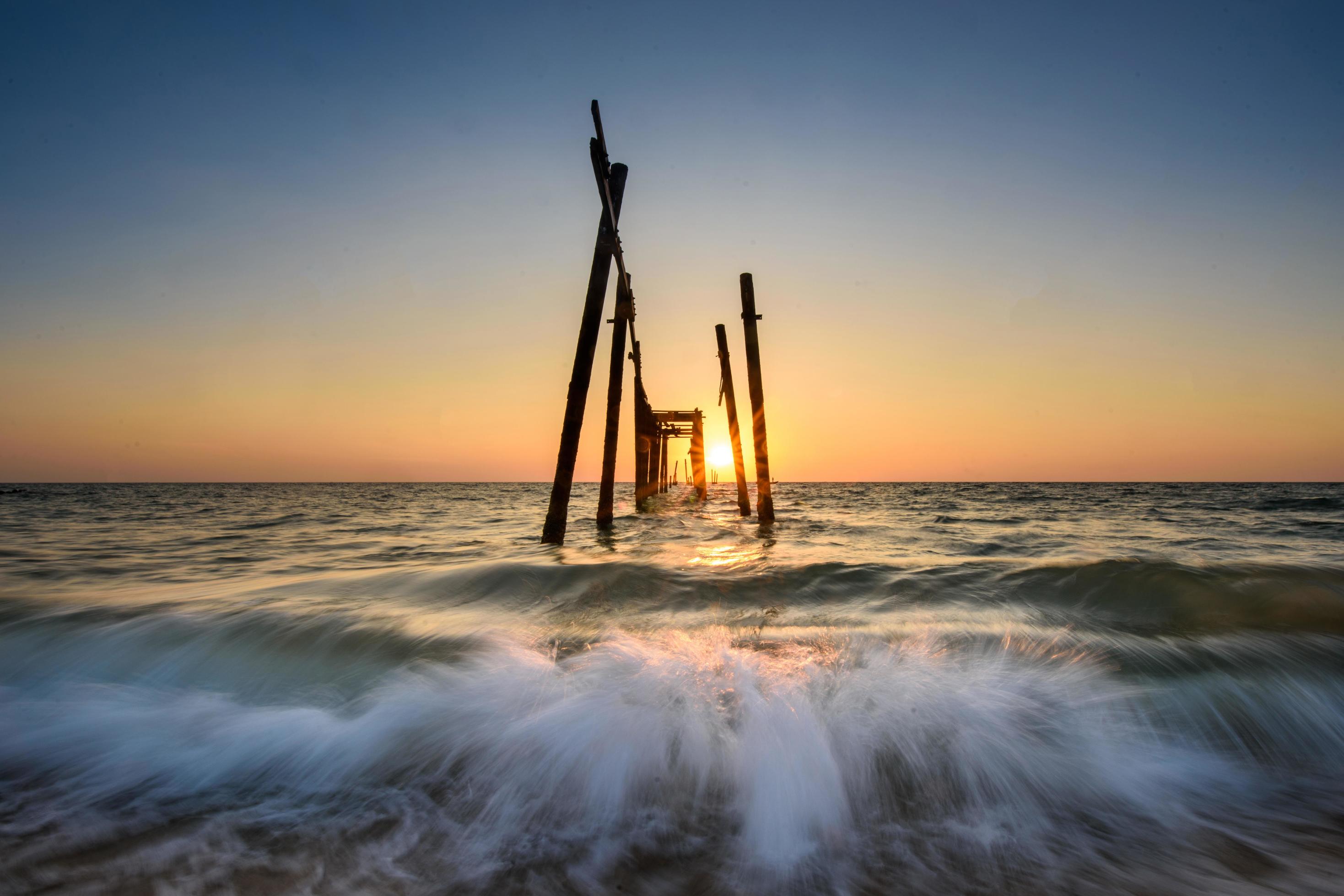 broken wooden bridge sunset on the sea at Phangnga, Thailand Stock Free