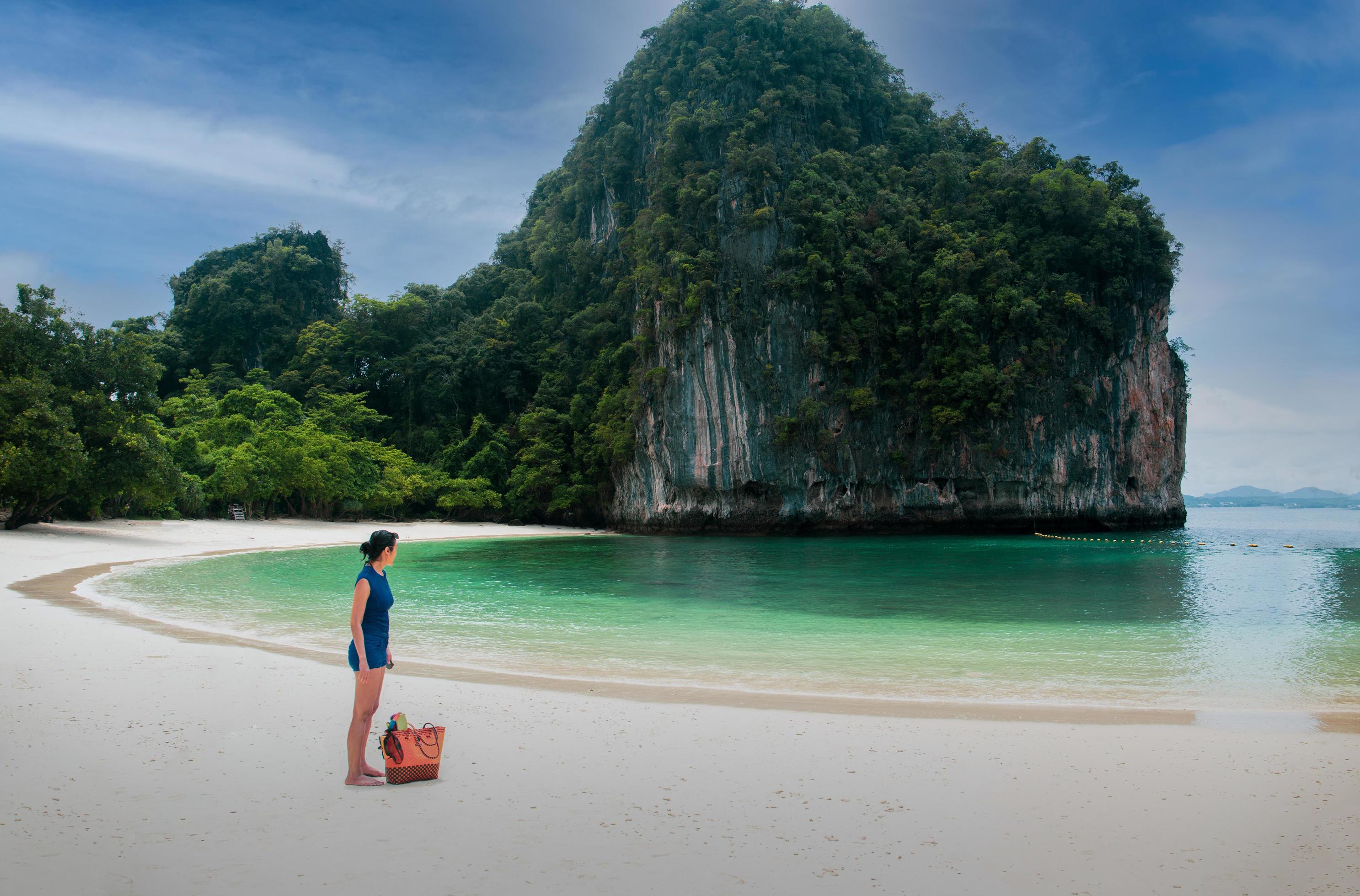 Woman standing on the beach looking at beautiful ocen in tropical island. Stock Free