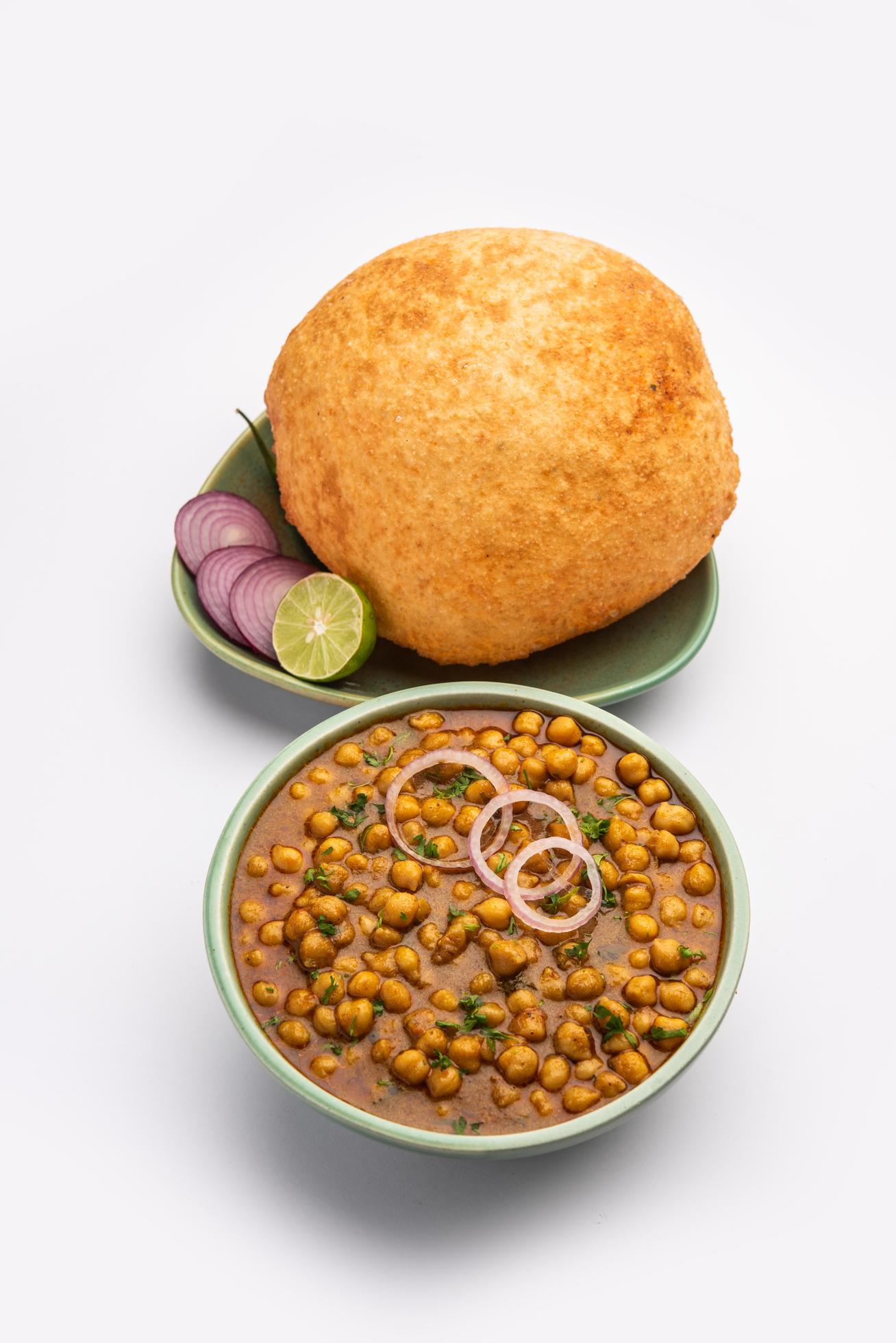 Chole bhature is a North Indian food dish. A combination of chana masala and bhatura or puri Stock Free