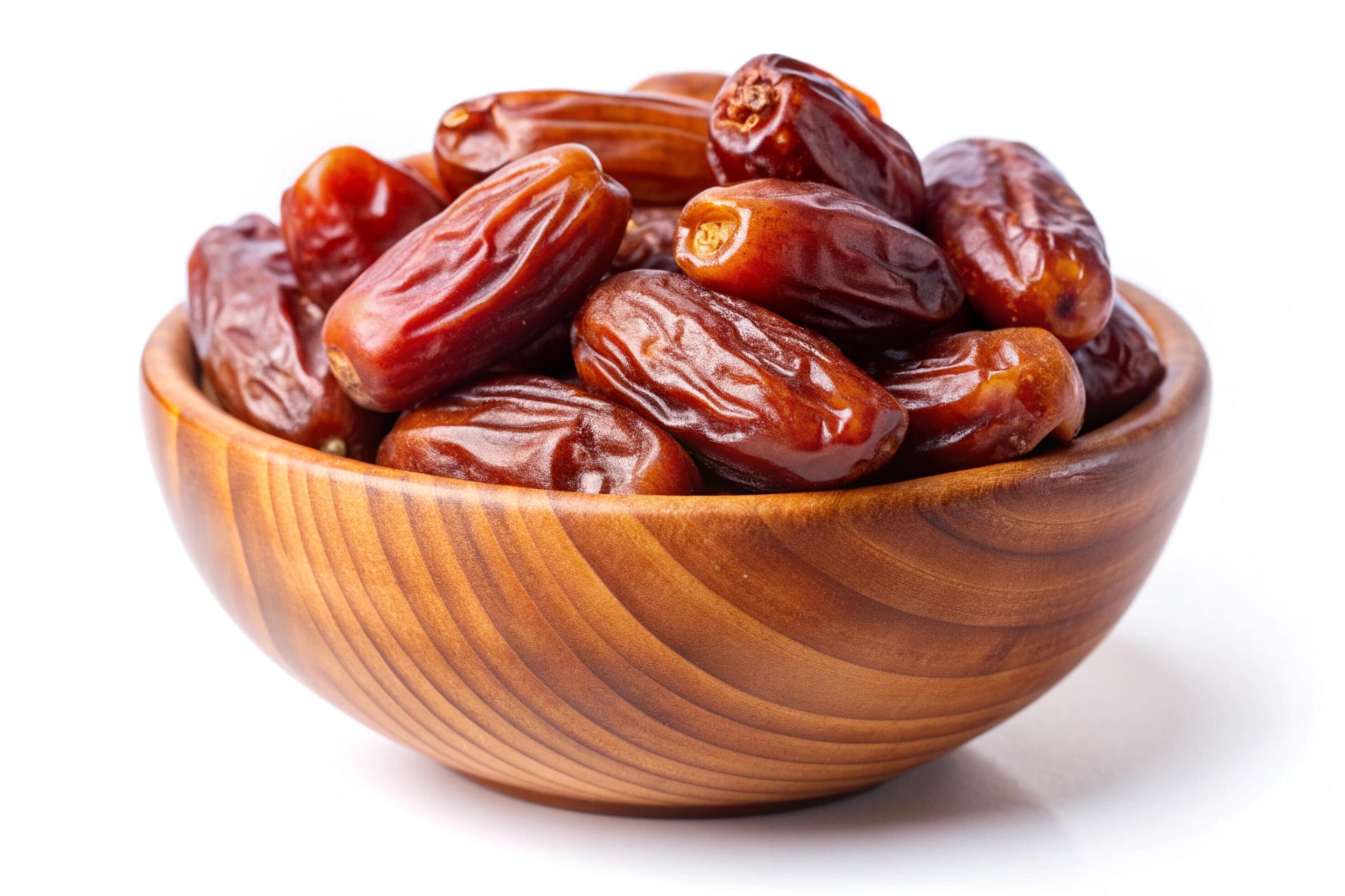 Dates in wood bowl isolated on white background Stock Free