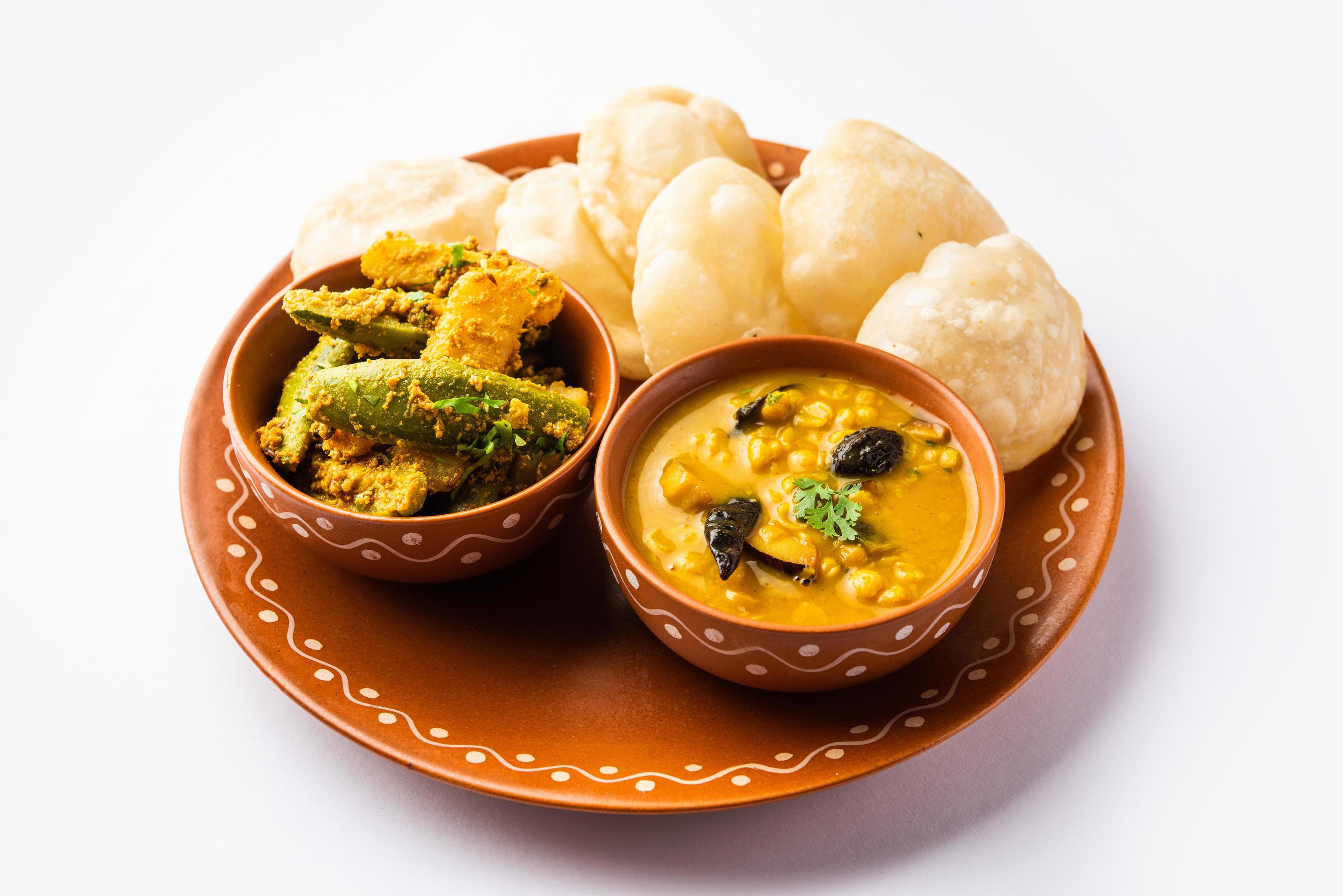 Cholar dal and patol aloo sabzi served with fried Luchi or poori, bengali food Stock Free