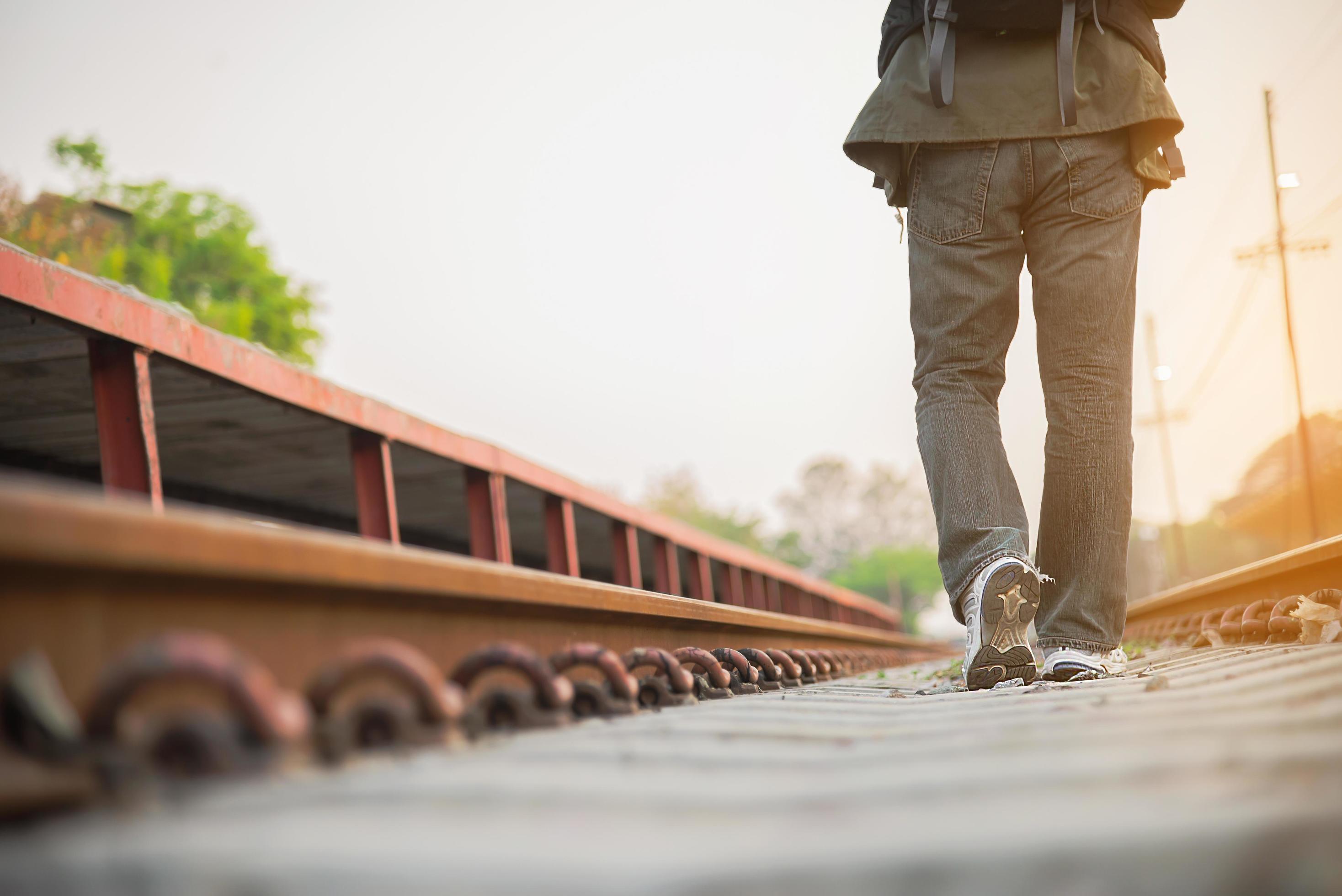 Travel man wait train at platform – people vacation lifestyle activities at train station transportation concept Stock Free