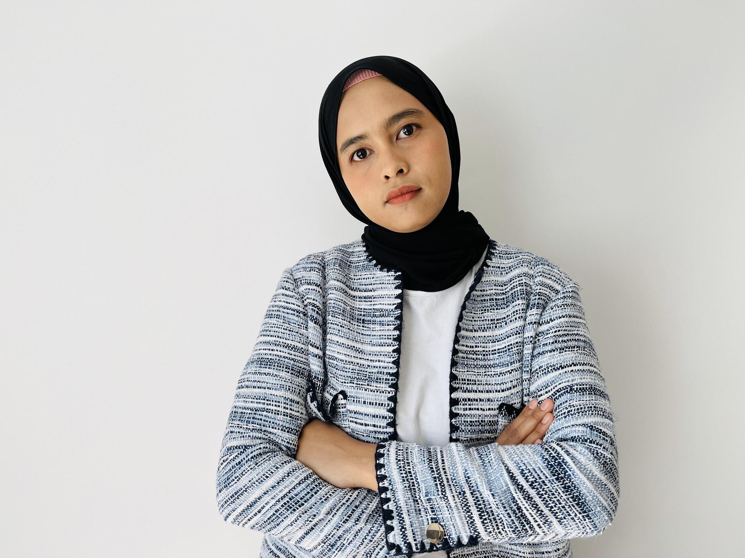 Seriously face young Asian Muslim woman crossed arms and looking confident isolated over white background Stock Free