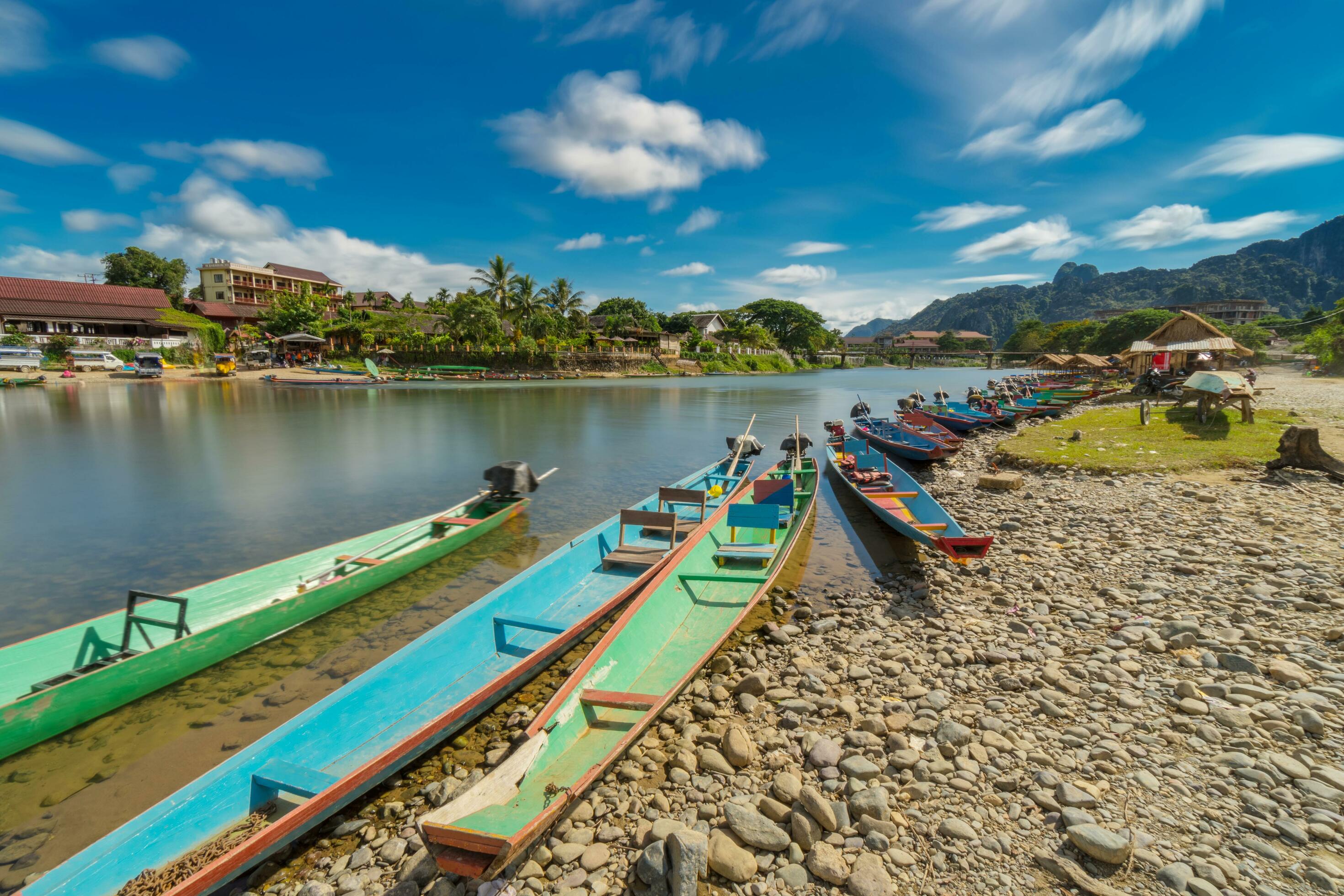 Long exposure and long tail boats on naw song river in Vang vieng, Laos. Stock Free