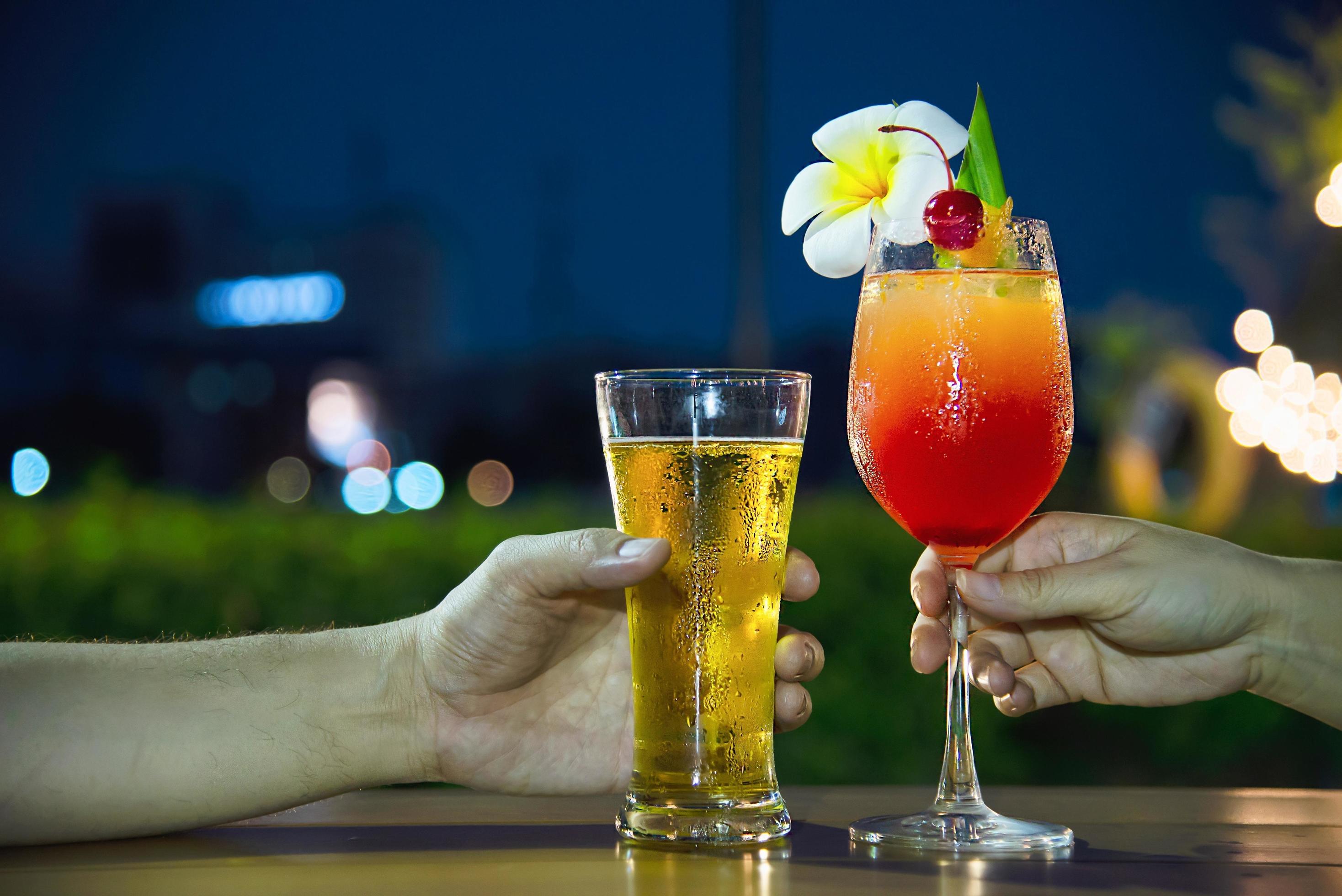 Couple celebration in restaurant with soft drink beer and mai tai or mai thai – happy lifestyle people with soft drink concept Stock Free