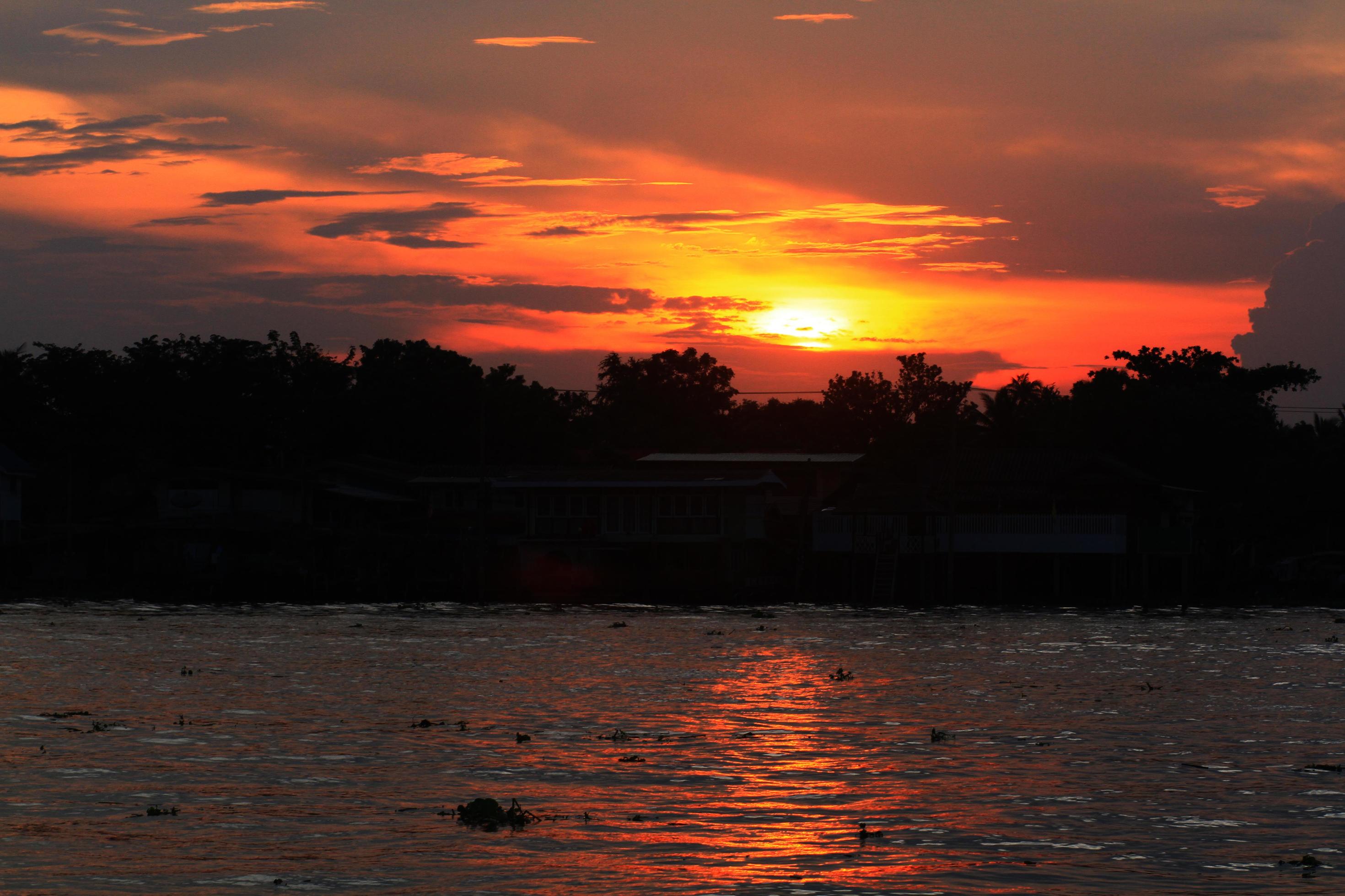 Beautiful dramatic of twilight in sunset on river and riverside in Thailand Stock Free