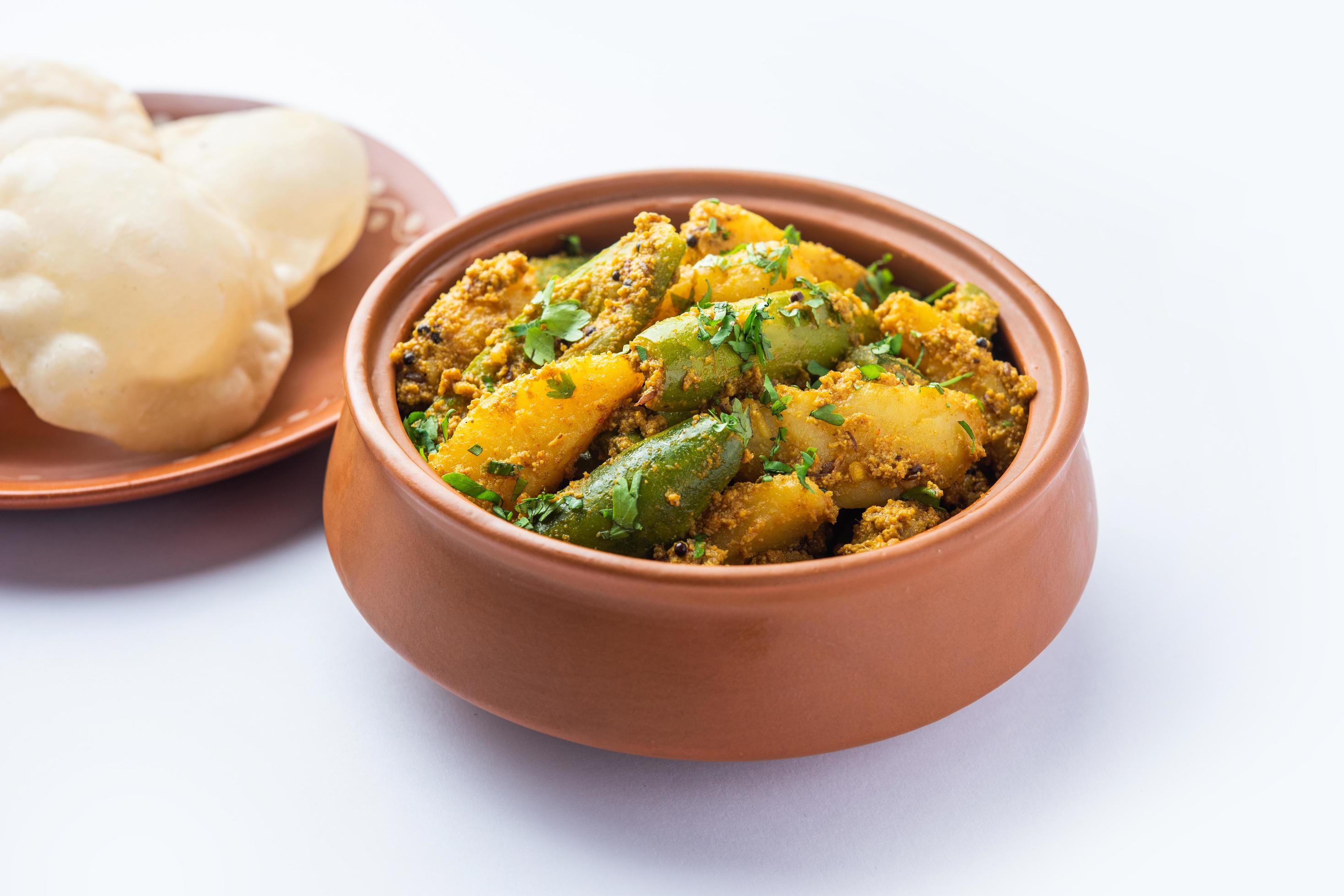 Aloo Patol sabzi made using pointed gourd and potato served with fried Luchi or poori, Bengali food Stock Free