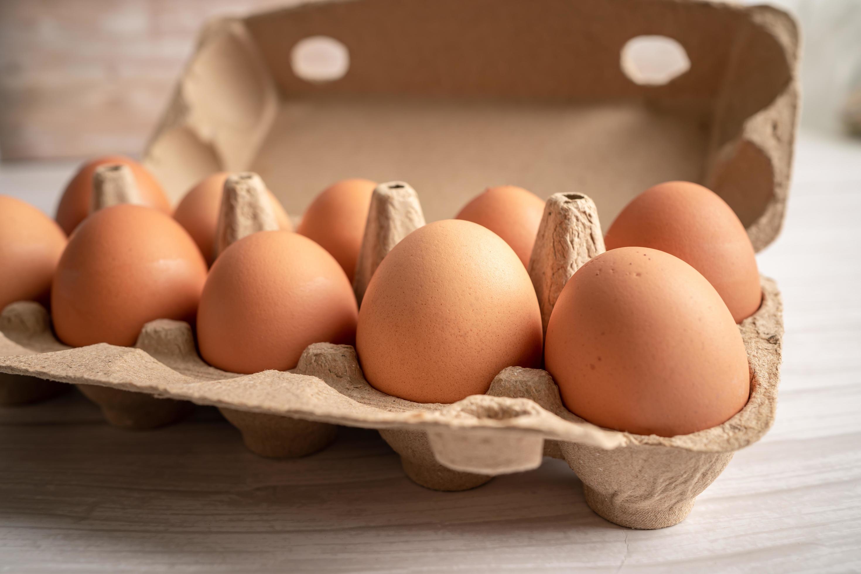 Organic fresh eggs in cardboard container pack, organic healthy food. Stock Free