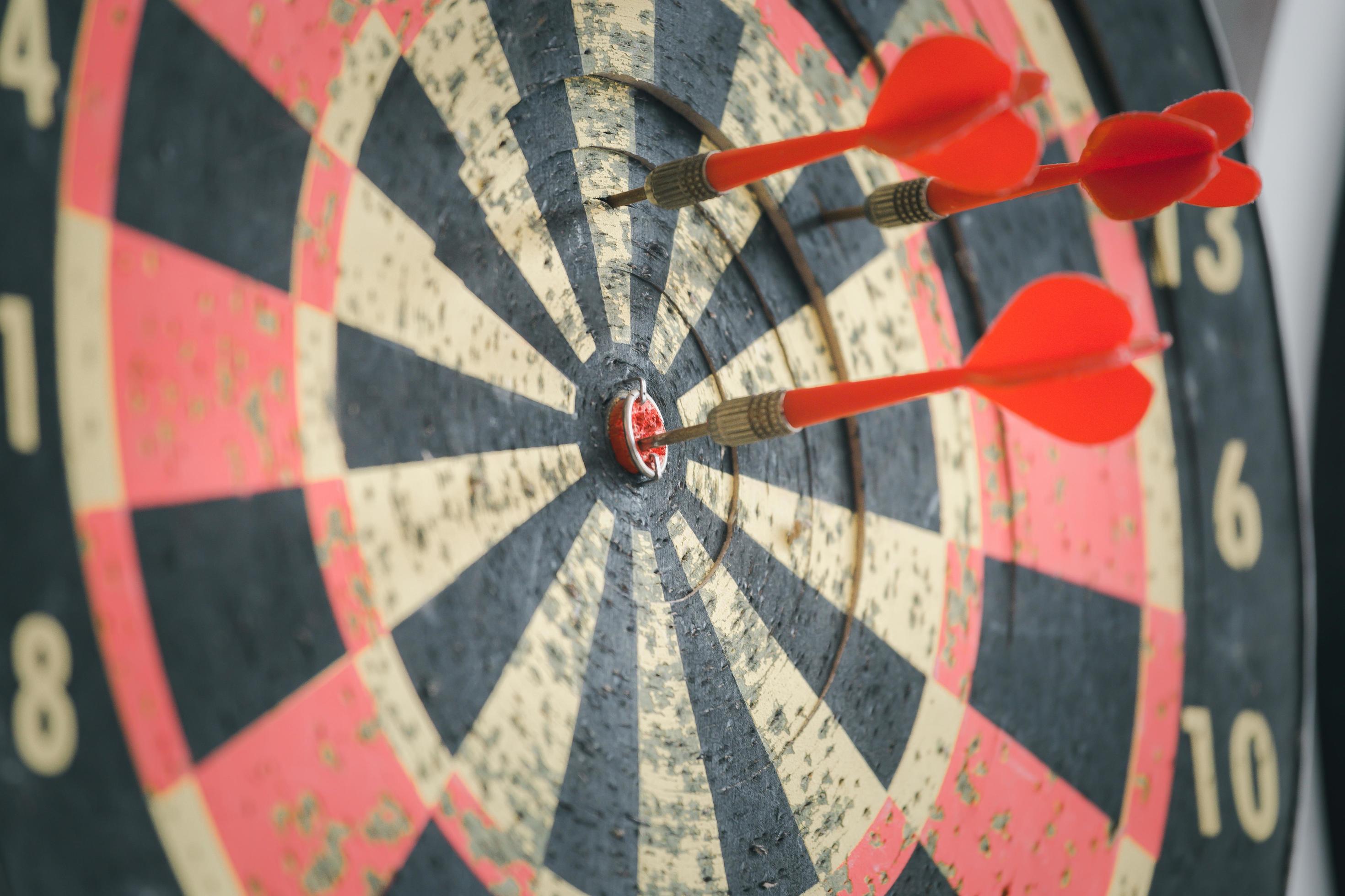 Red dart arrow hit on the old dartboard, Business target and goal concept Stock Free