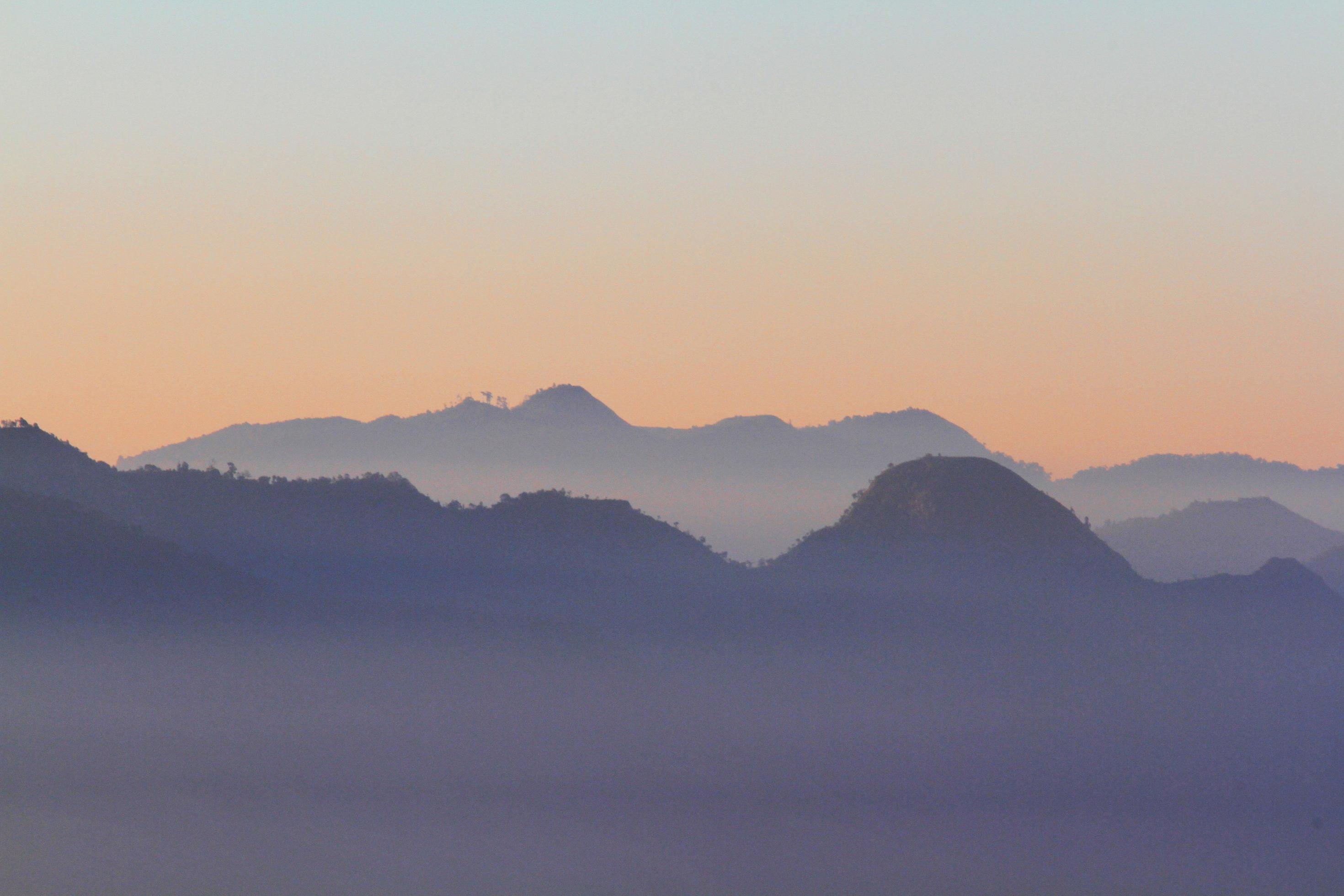 Beautiful Sunset and sunrise on sky and golden twilight time with mist and fog in valley of mountain layer Stock Free