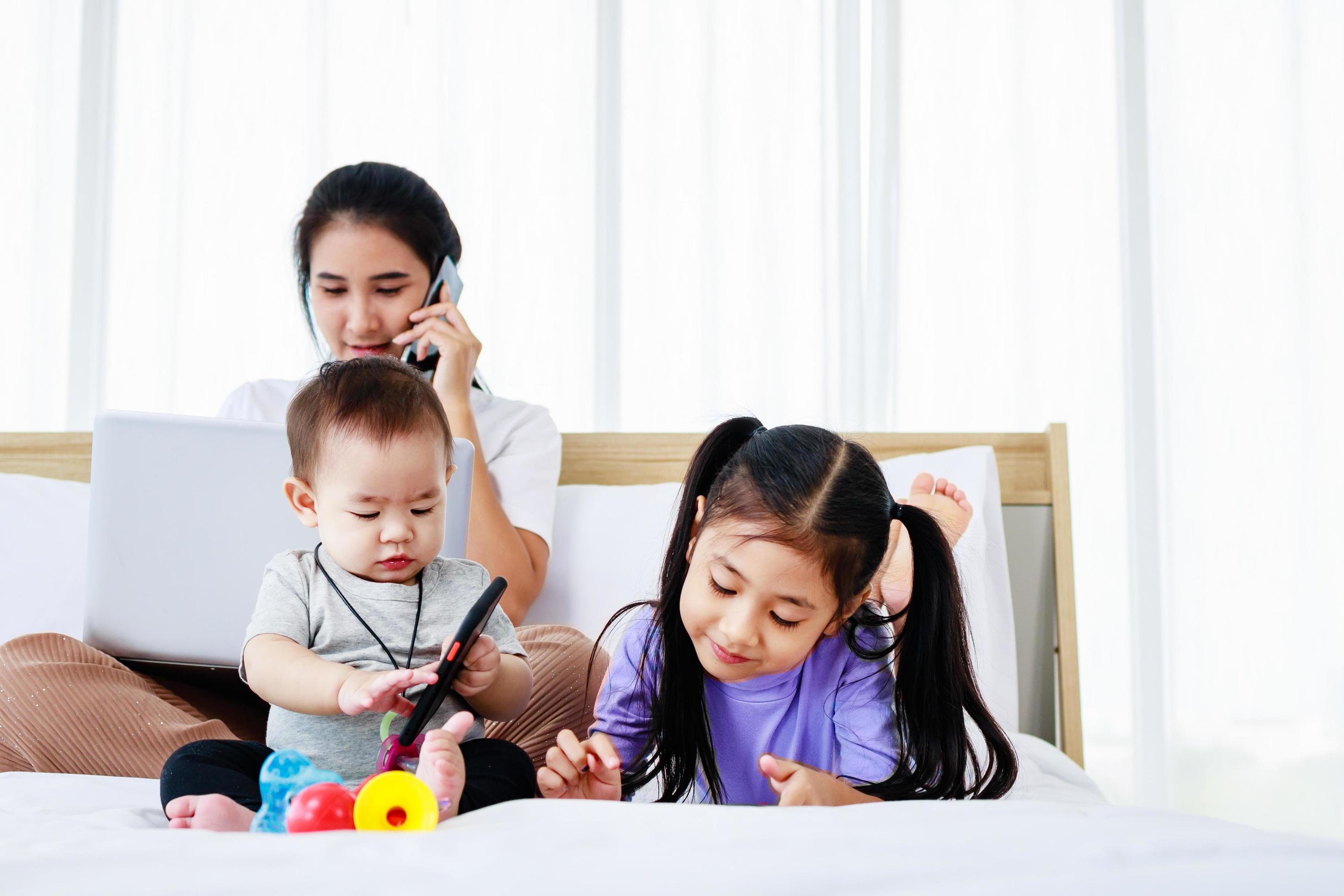 Asian Mother with baby daughter girl and baby using laptop home lifestyle Stock Free