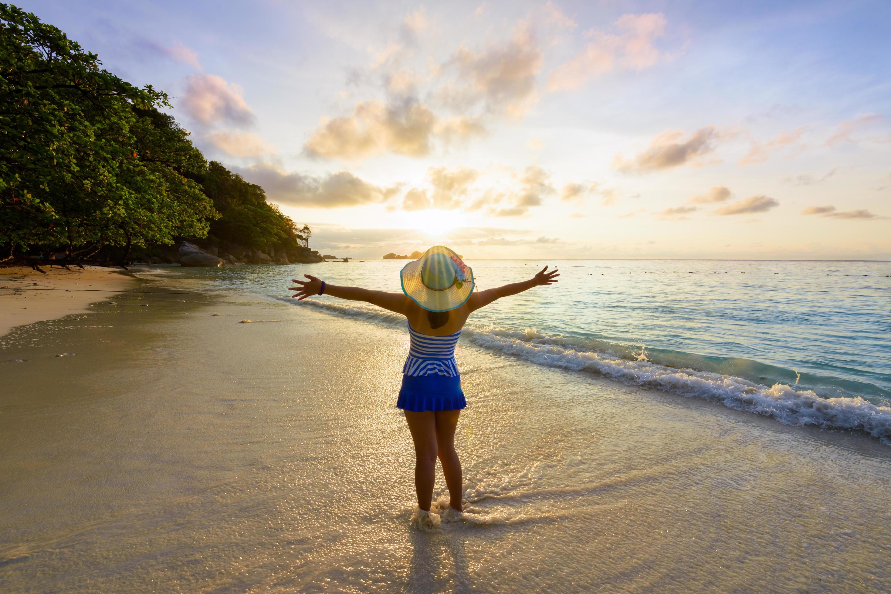 Happy girl on the beach at sunrise Stock Free