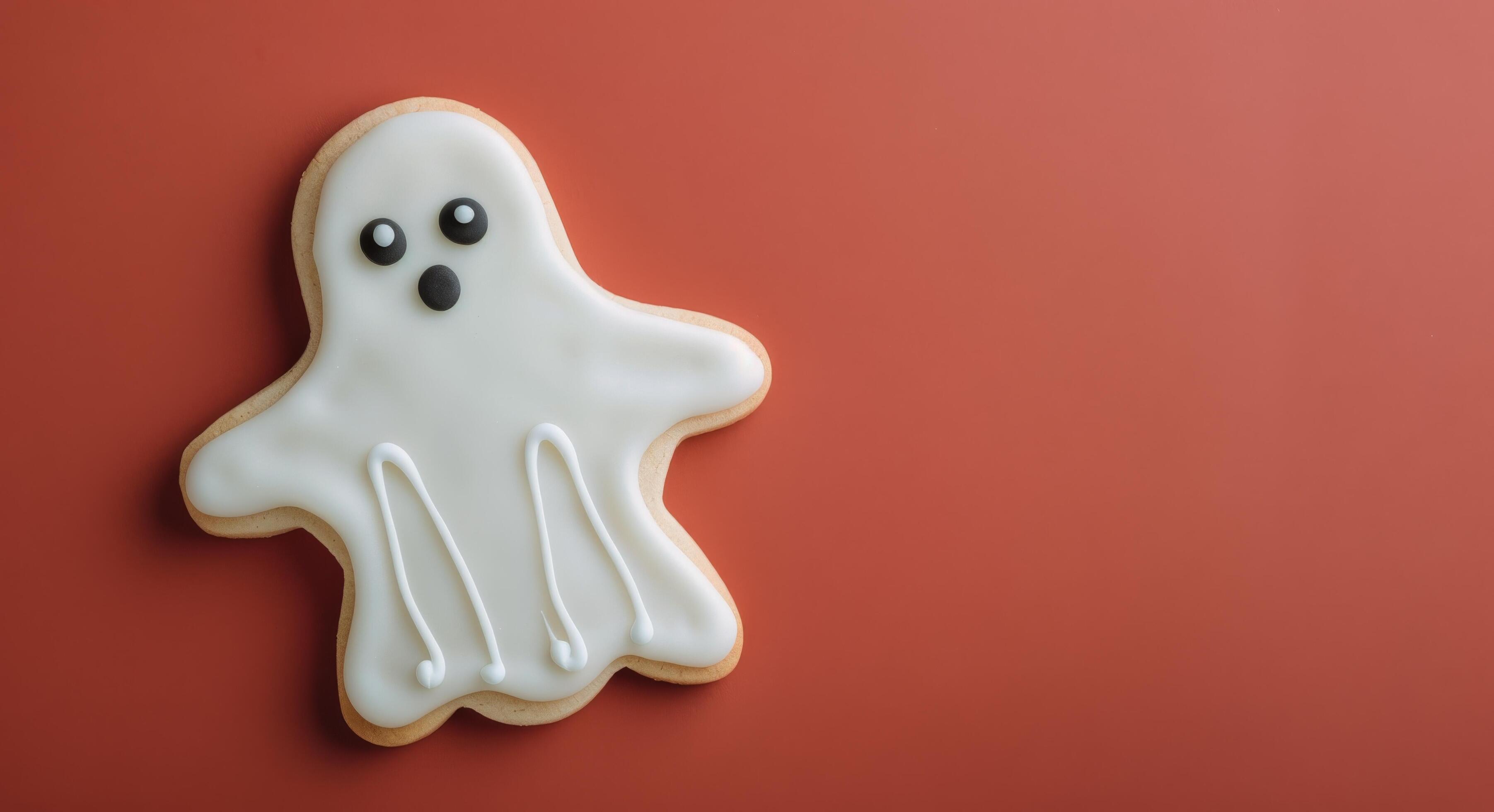 Cute Ghost-Shaped Cookie on Red Background for Halloween Celebration Stock Free