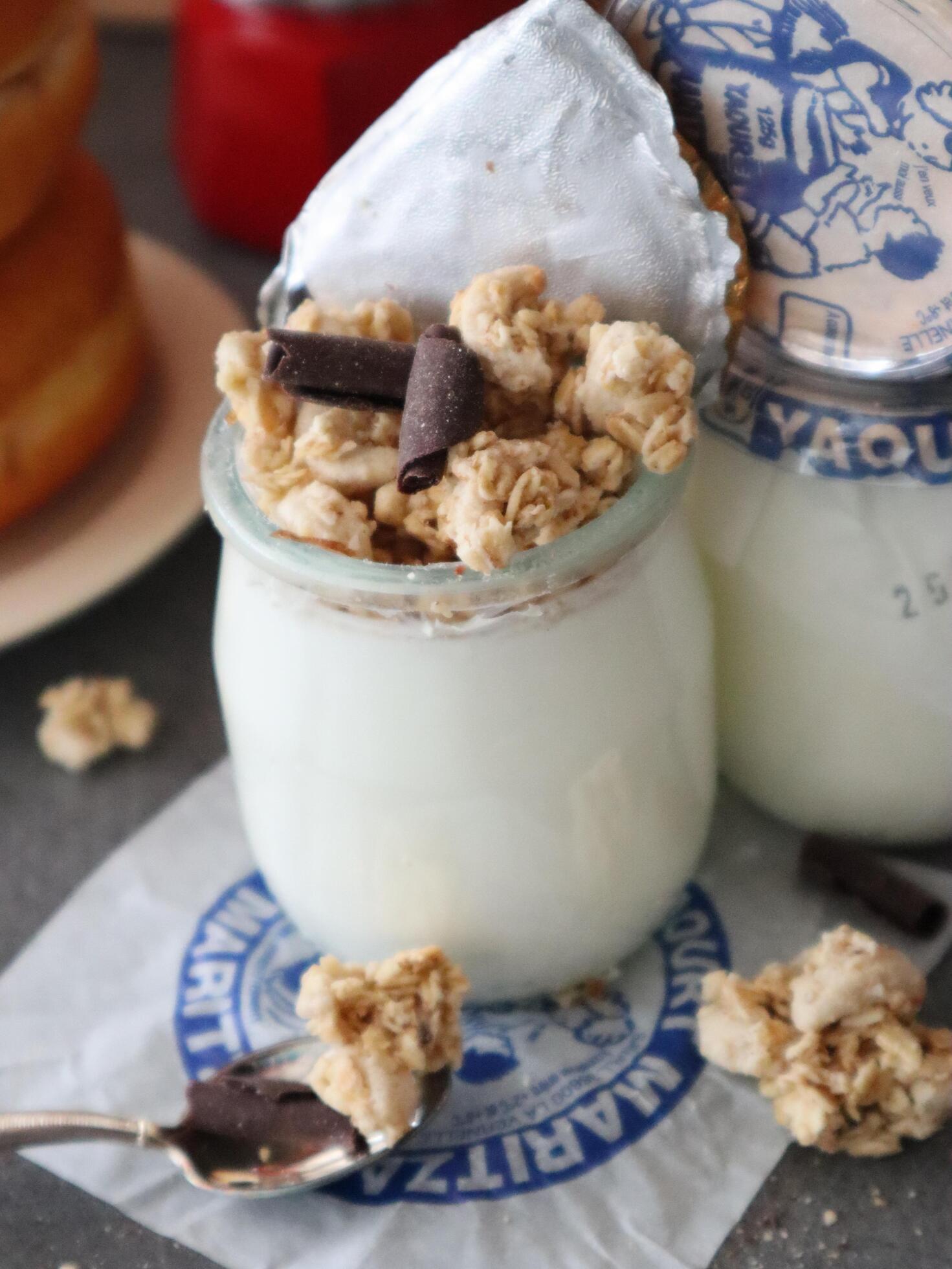 Glass jar with homemade yoghurt and granola breakfast Stock Free