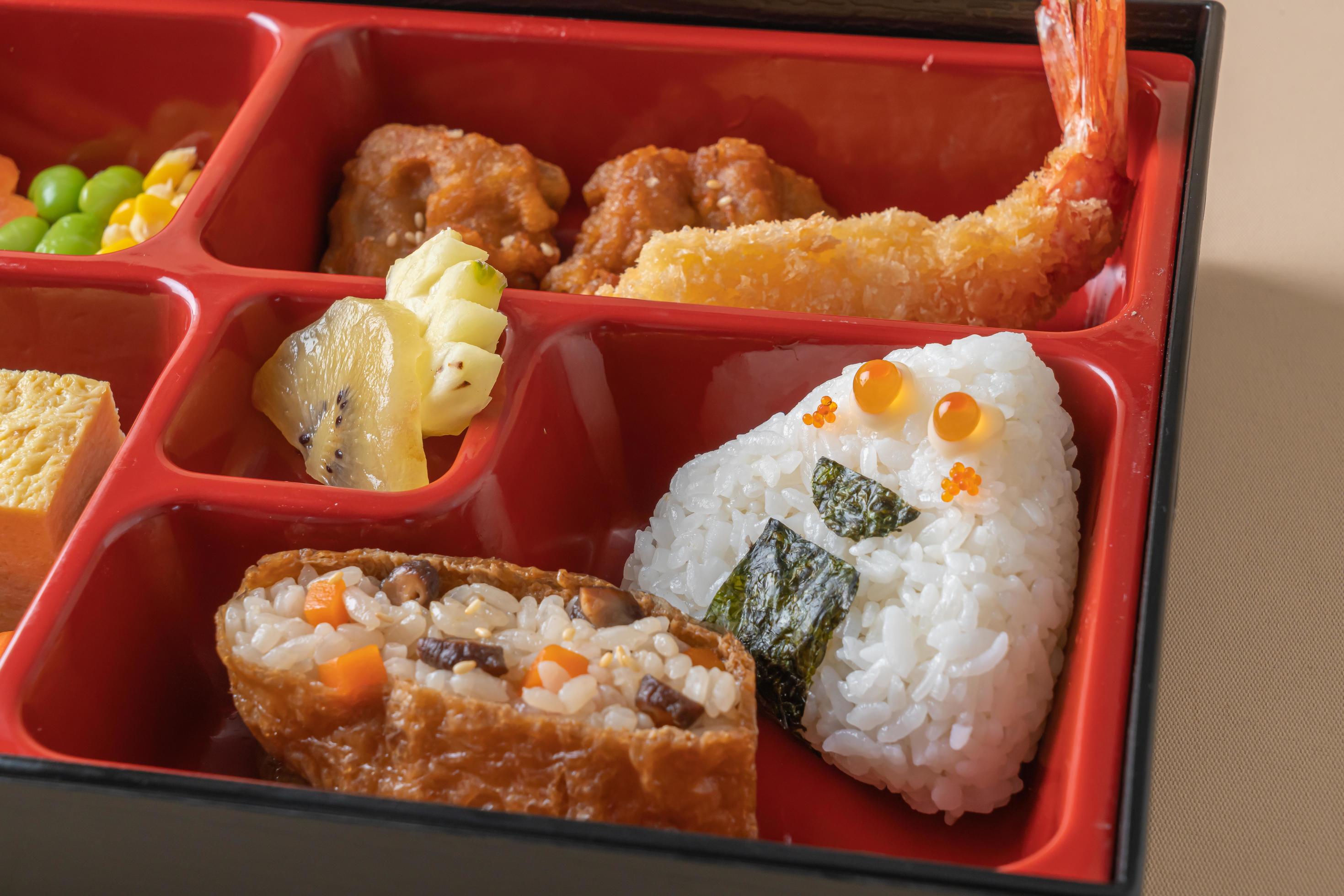 Inari sushi rice wrapped in dried tofu with fried shrimp and fried chicken in bento set – Japanese food style Stock Free