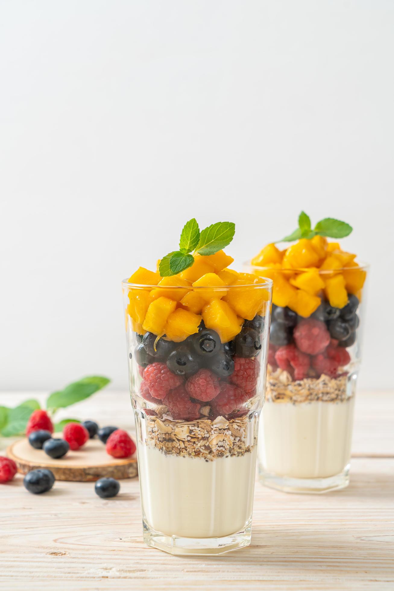 Homemade mango, raspberry, and blueberry with yogurt and granola – healthy food style Stock Free