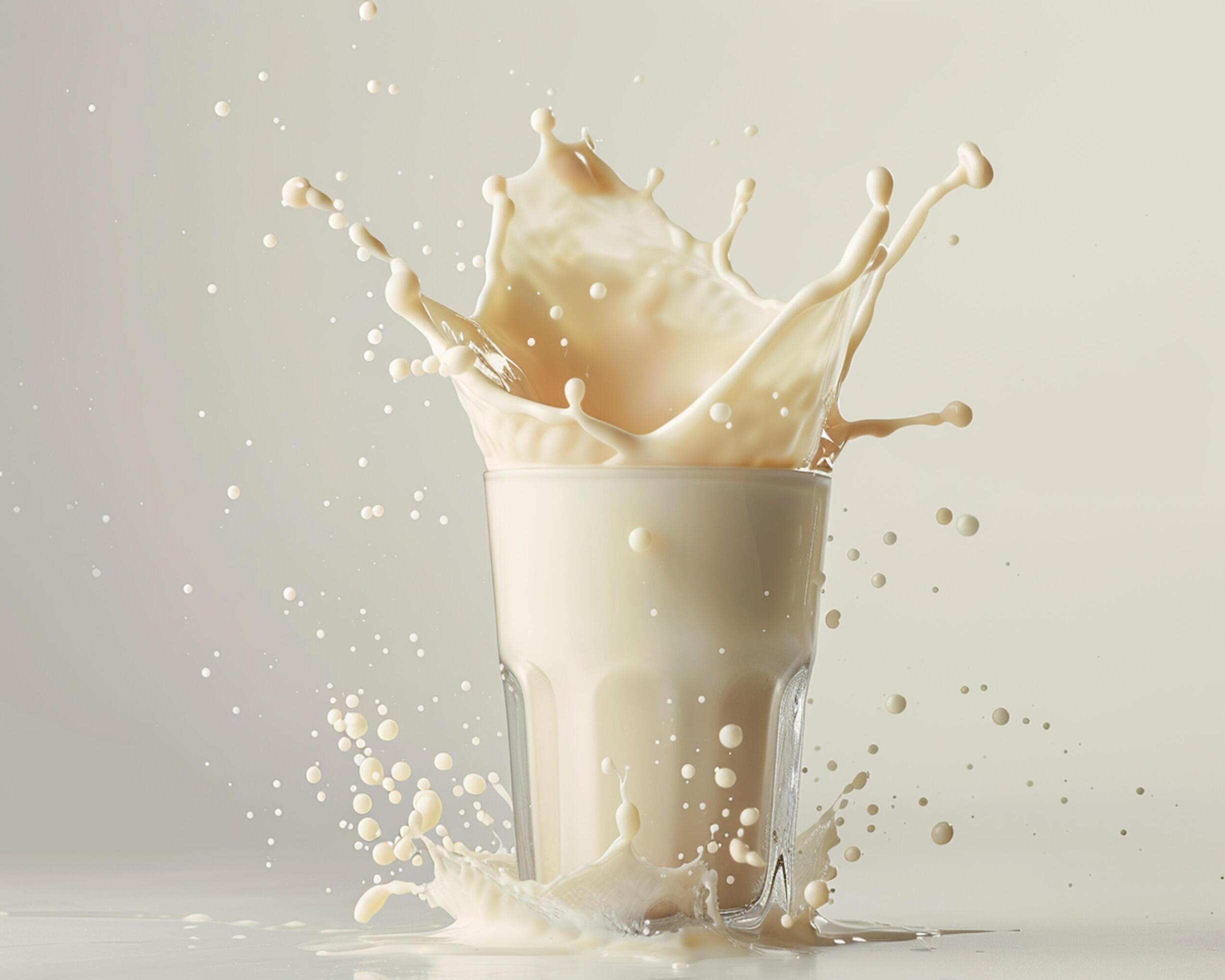 a glass of milk is splashing into the air Stock Free