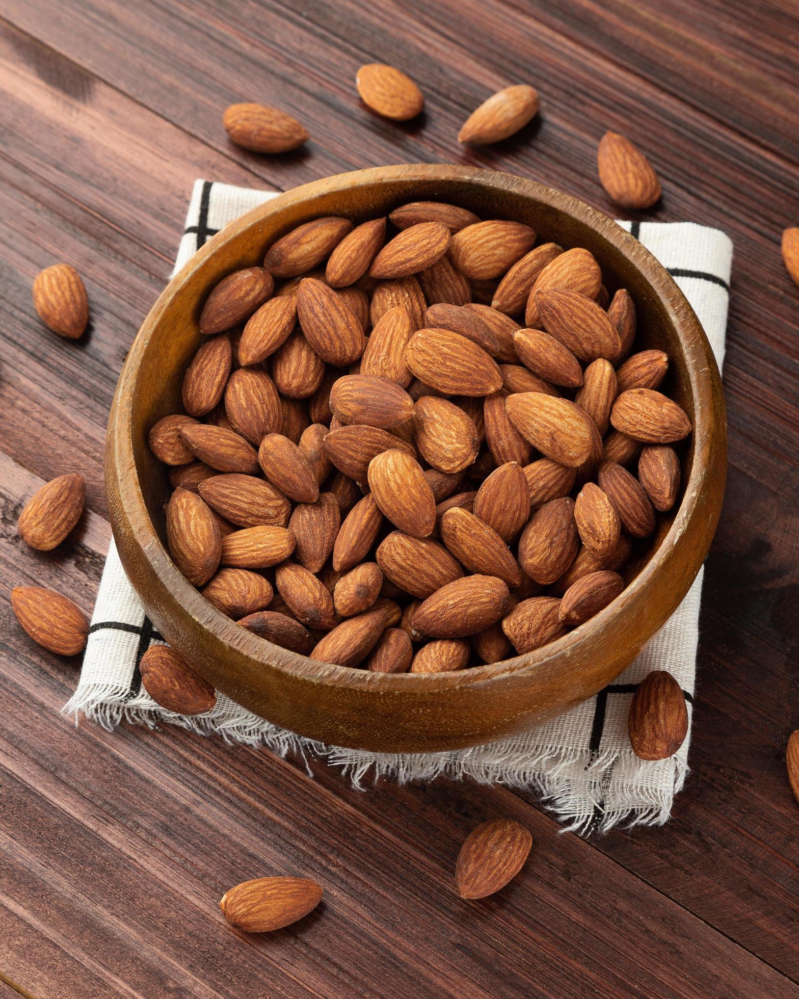 Almonds in wooden bowl on the table, Healthy snack, Vegetarian food Stock Free