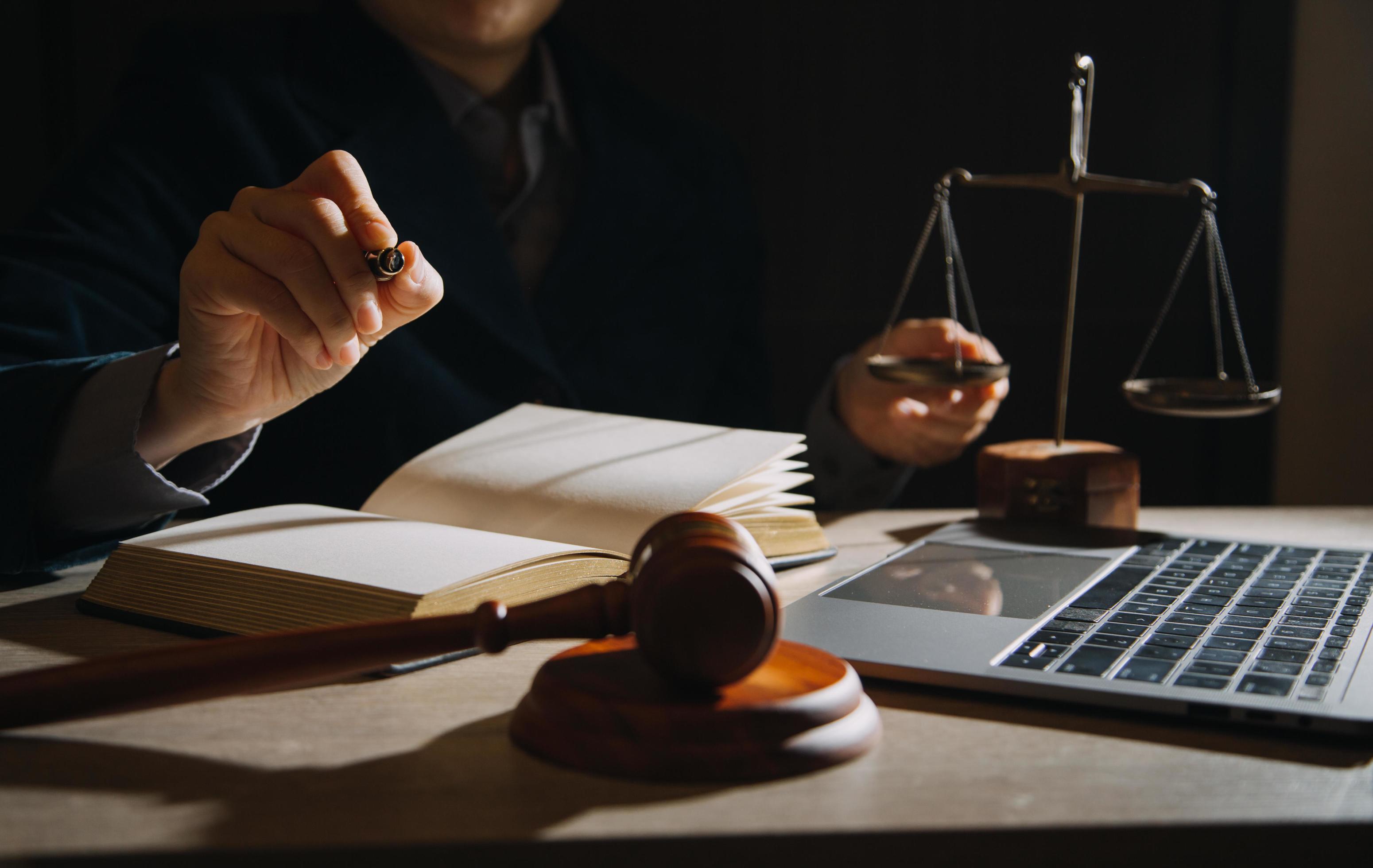 Business and lawyers discussing contract papers with brass scale on desk in office. Law, legal services, advice, justice and law concept Stock Free