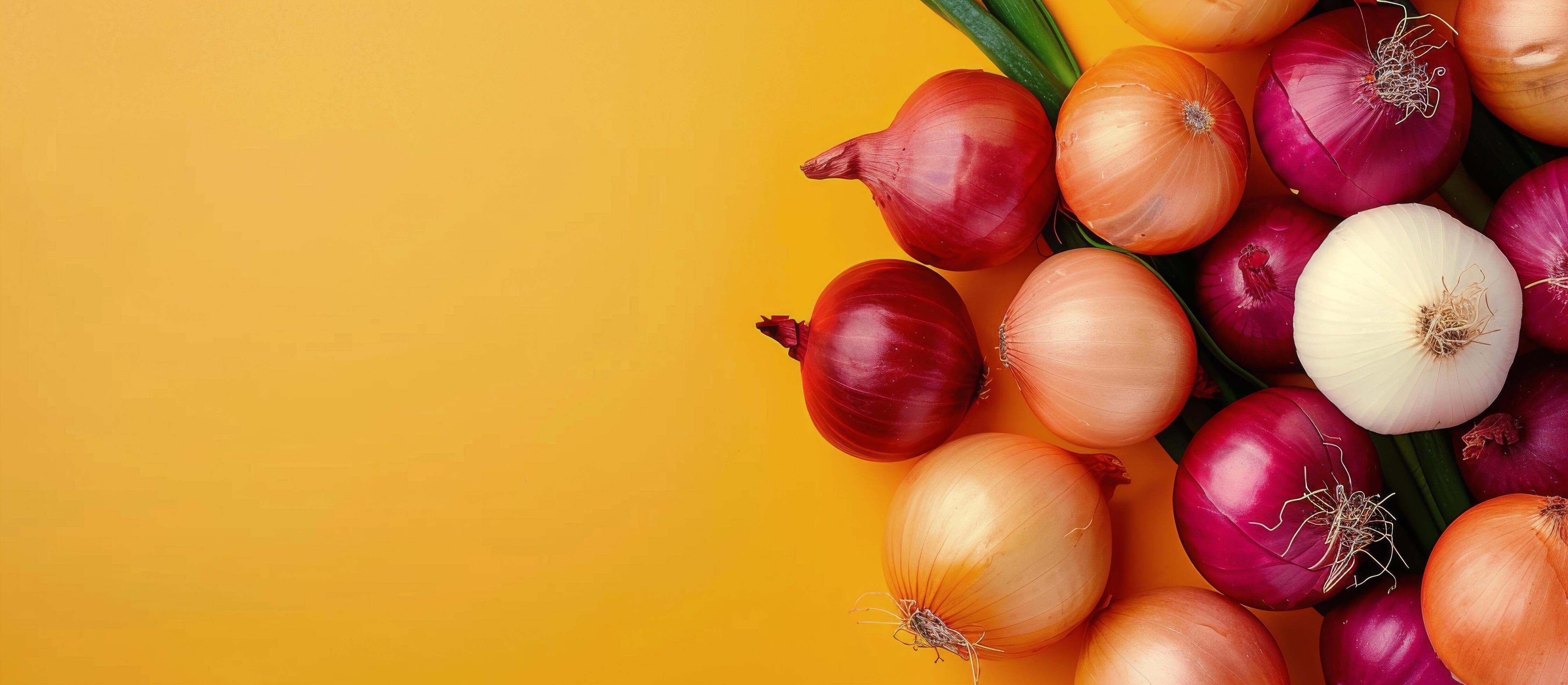 Variety of Fresh Onions on Yellow Background Stock Free