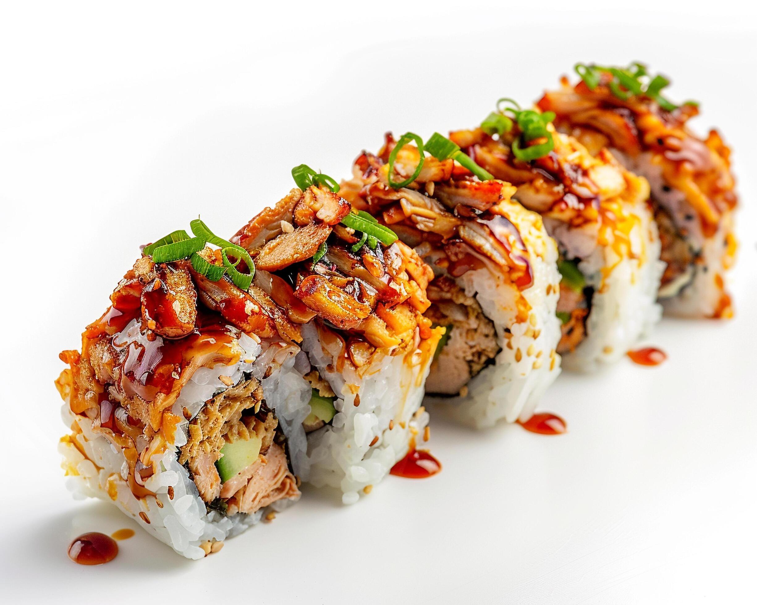 a sushi roll with sauce and green onions Stock Free