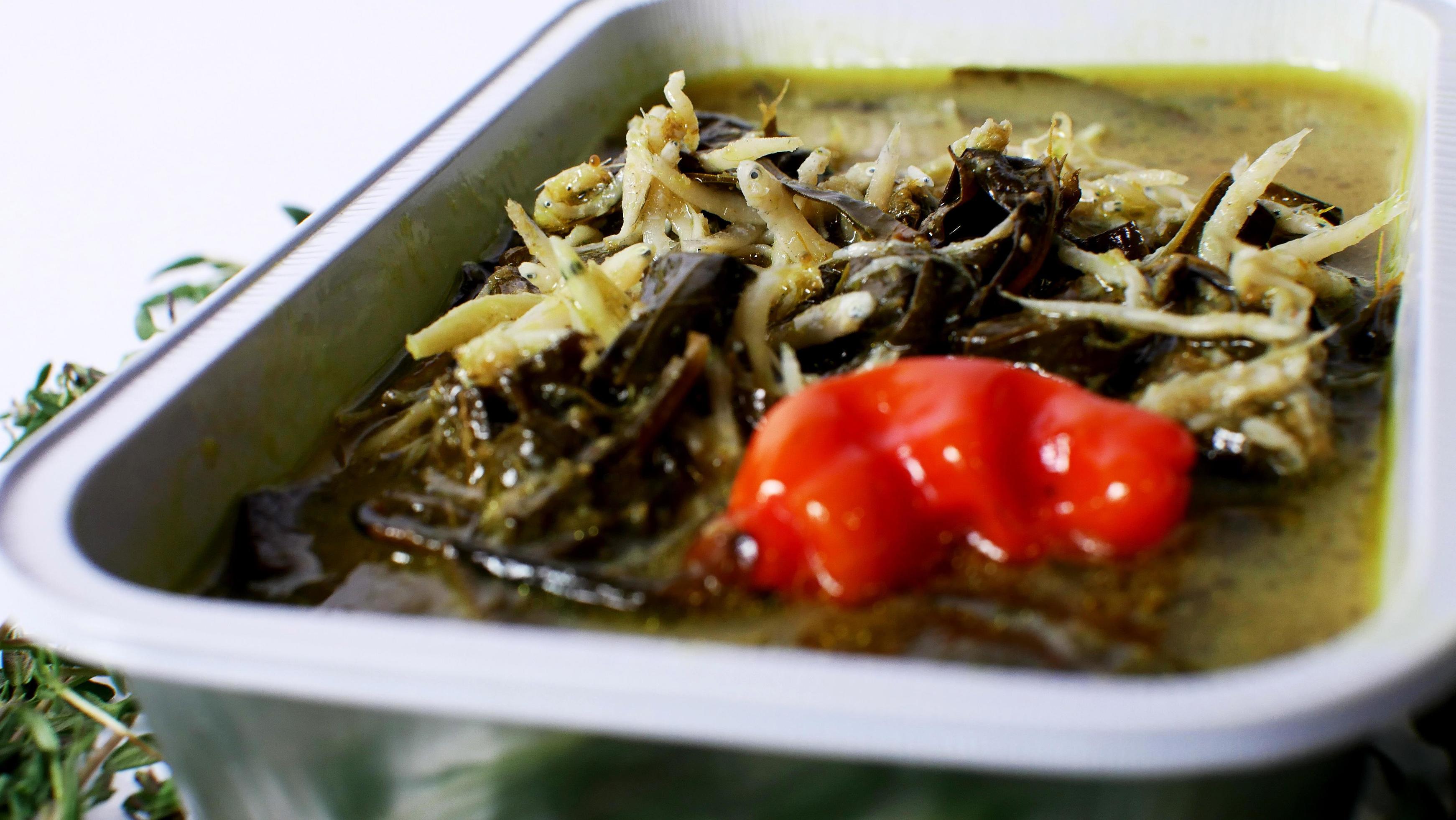 cassava leaf vegetable with anchovies Indonesian food served in an aluminum container with a white background Stock Free