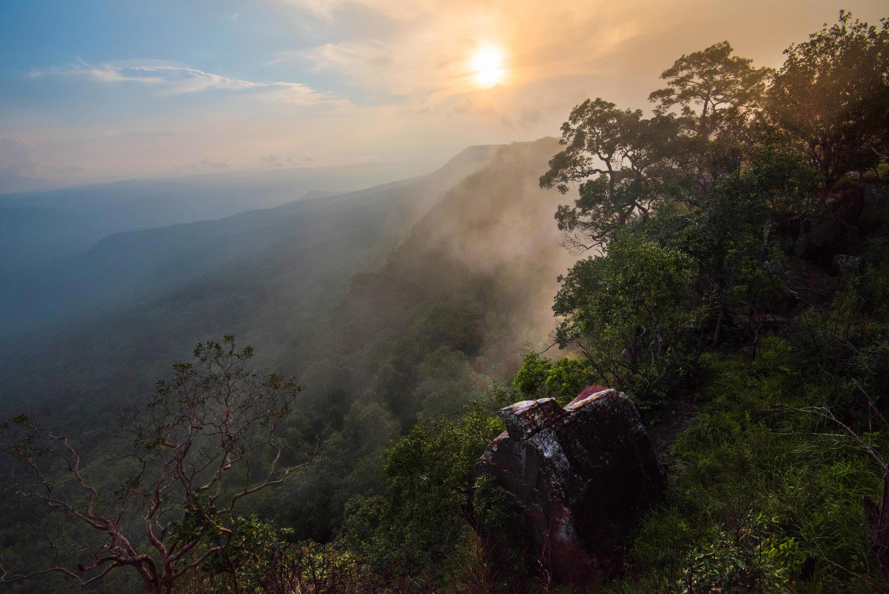 Wonderful landscape sunrise mountain with fog mist yellow and blue sky rising sunshine in the morning Stock Free