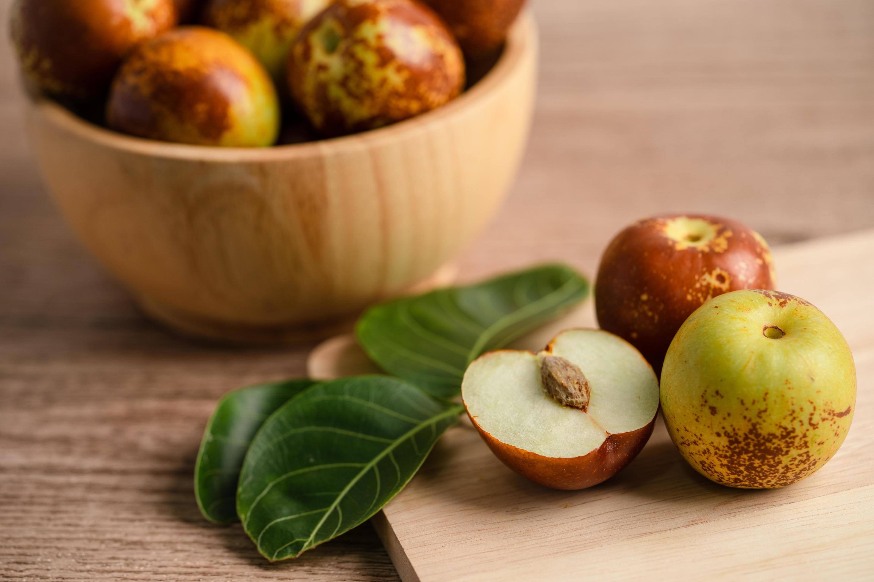 Jujube fruit or Chinese Dates in wooden bowl, healthy food. Stock Free