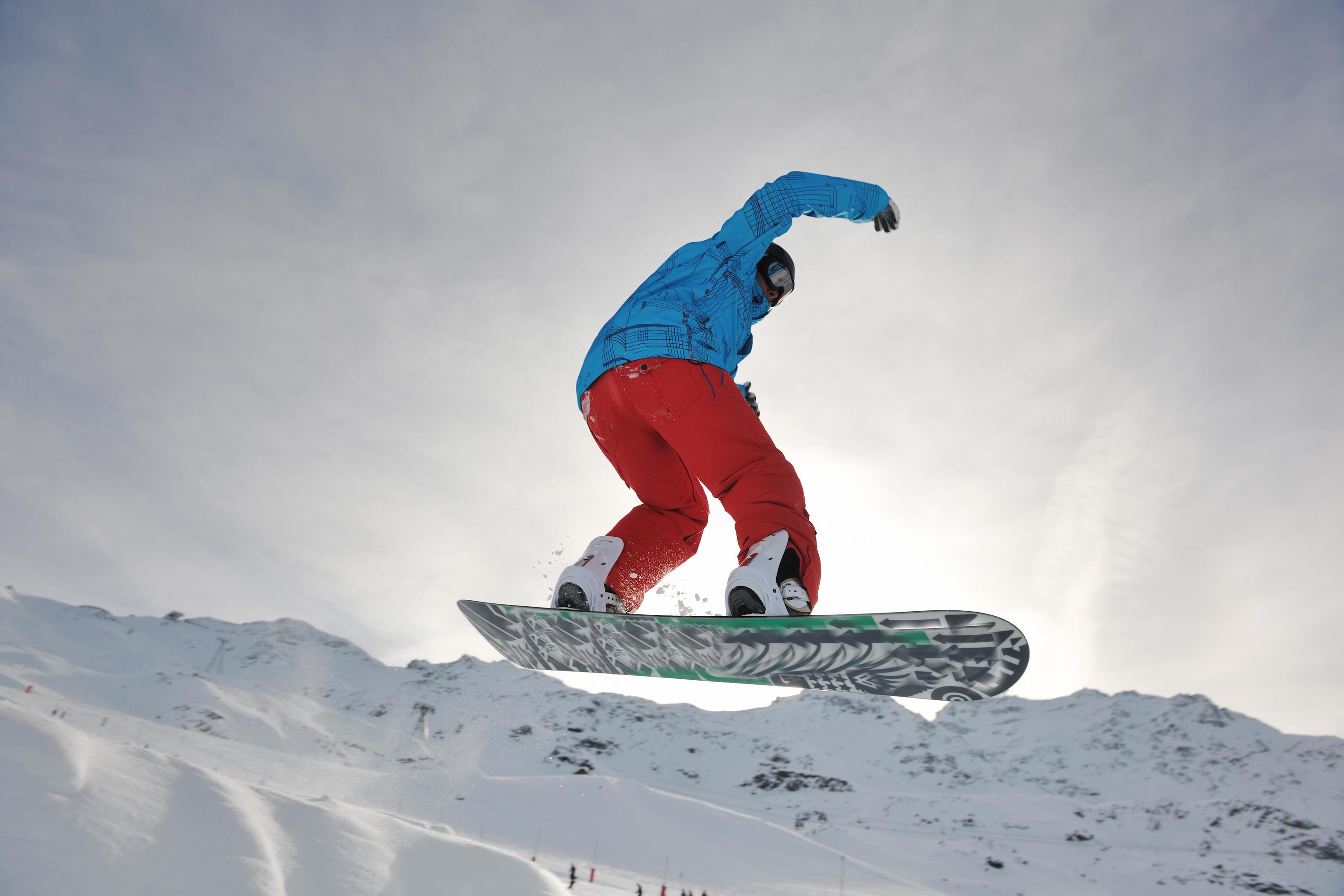 happy young man have fun at winter on mountain peak Stock Free