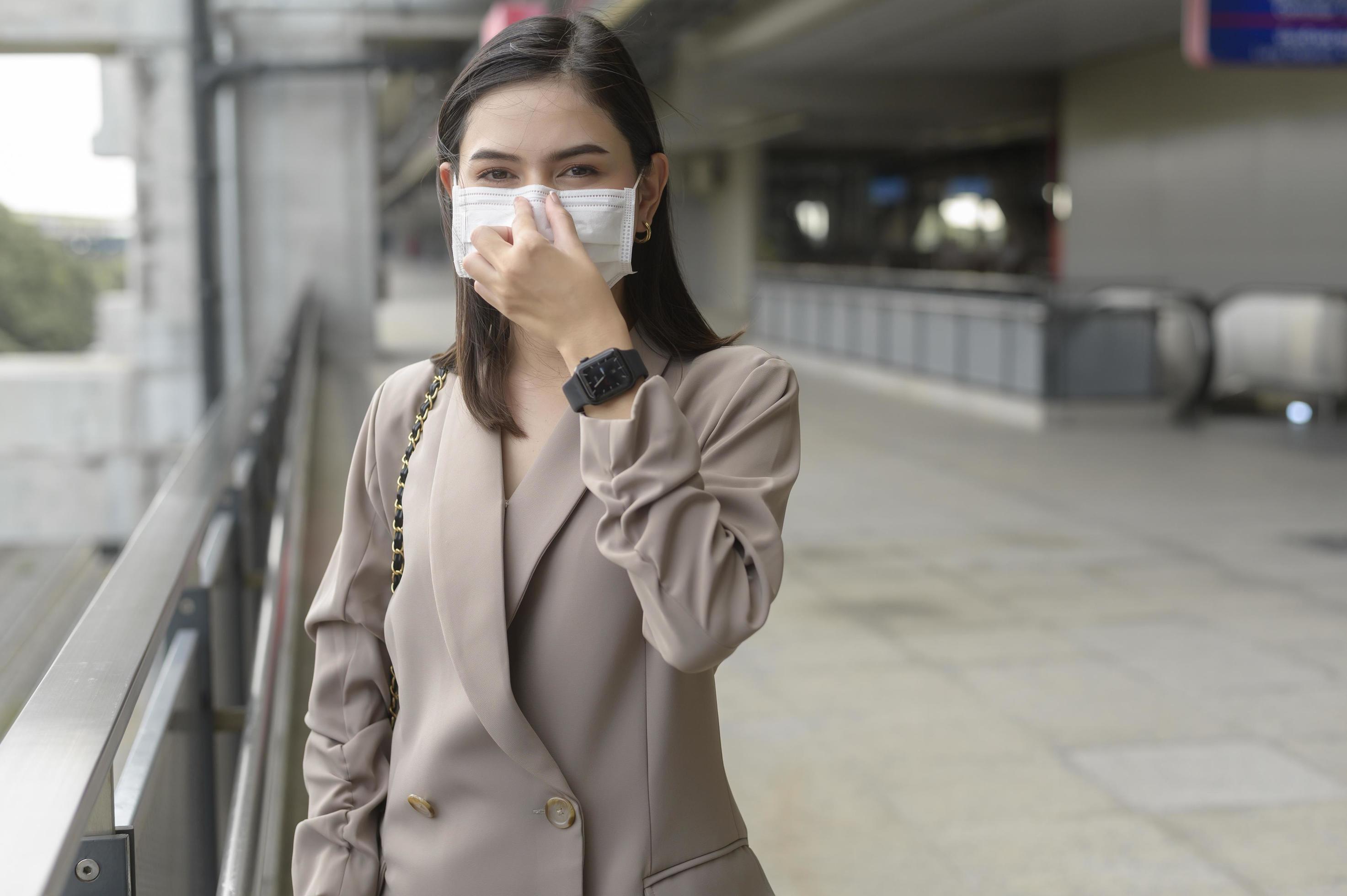 A portrait of Businesswoman is wearing face mask work in modern City , people lifestyle , working under Covid-19 pandemic concept Stock Free