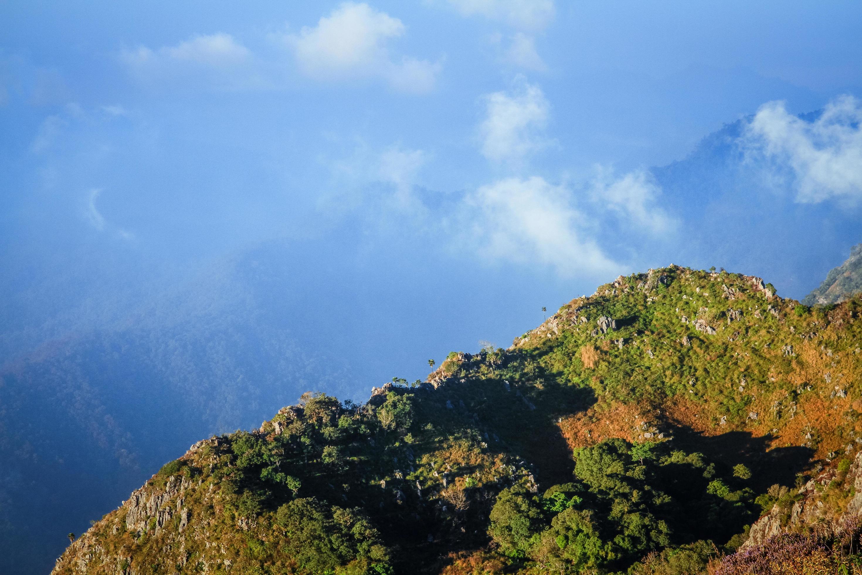 Sunrise in morning with sky and cloud on the Limestone mountain. Sunray with Fog and mist cover the jungle hill in Thailand Stock Free