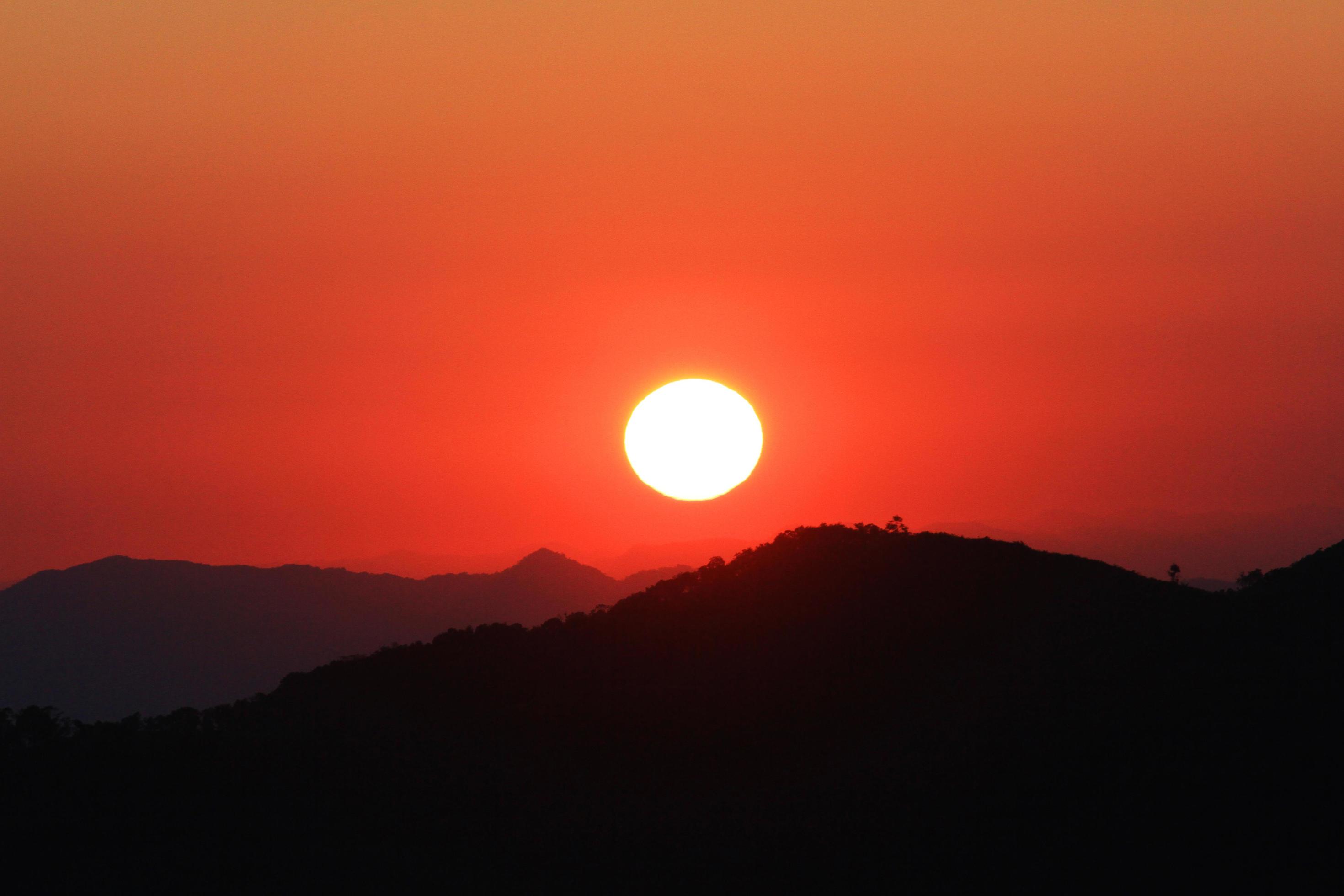 Sunset in sky and cloud, beautiful colorful twilight time with silhouette of mountain. Stock Free