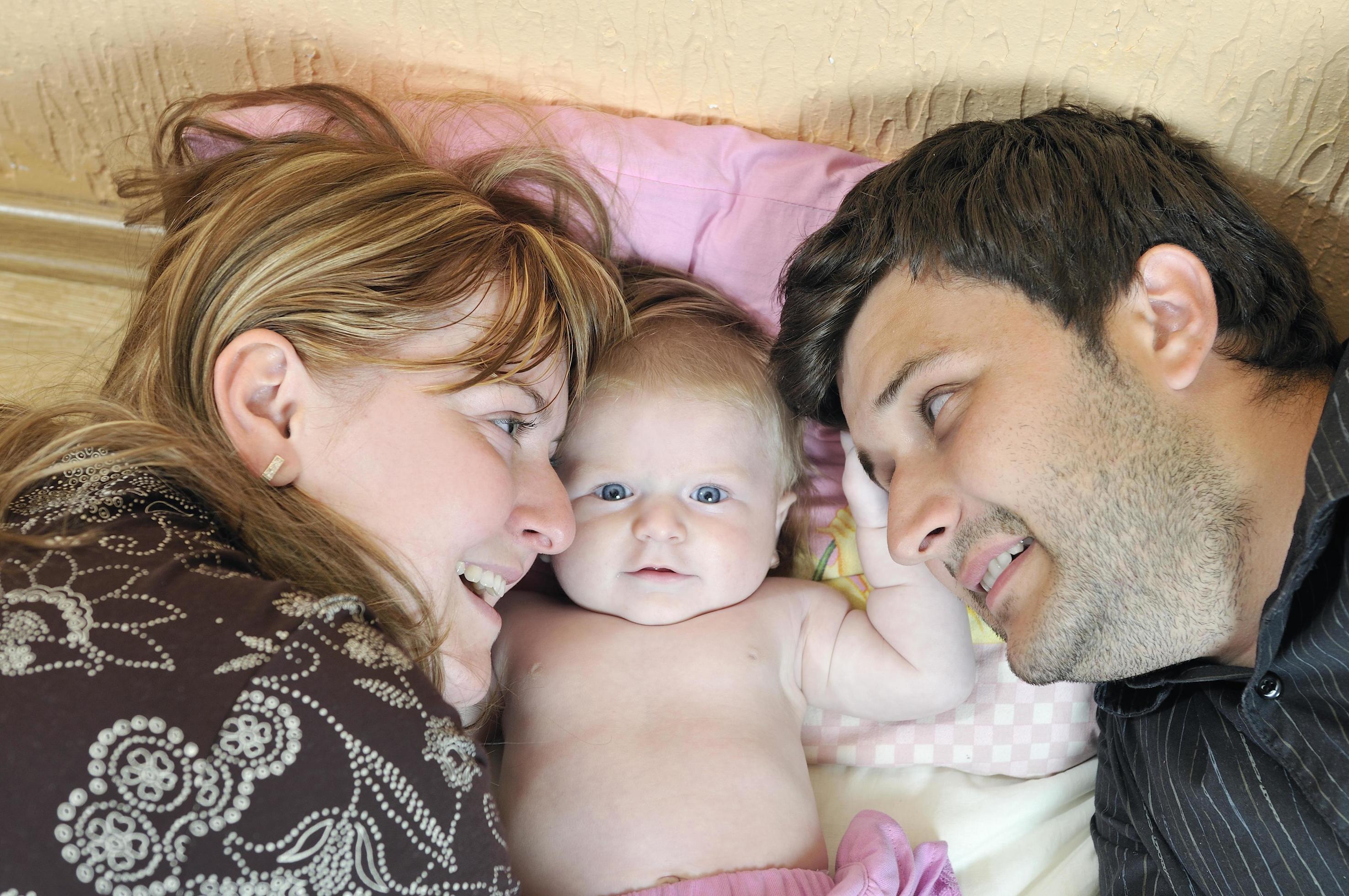 portrait of young family with cute little babby Stock Free