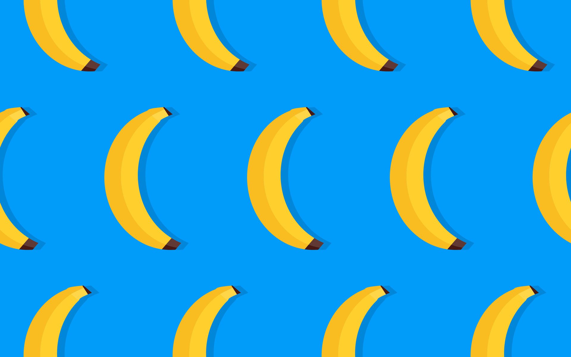 Seamless pattern with yellow bananas on a blue background Free Vector