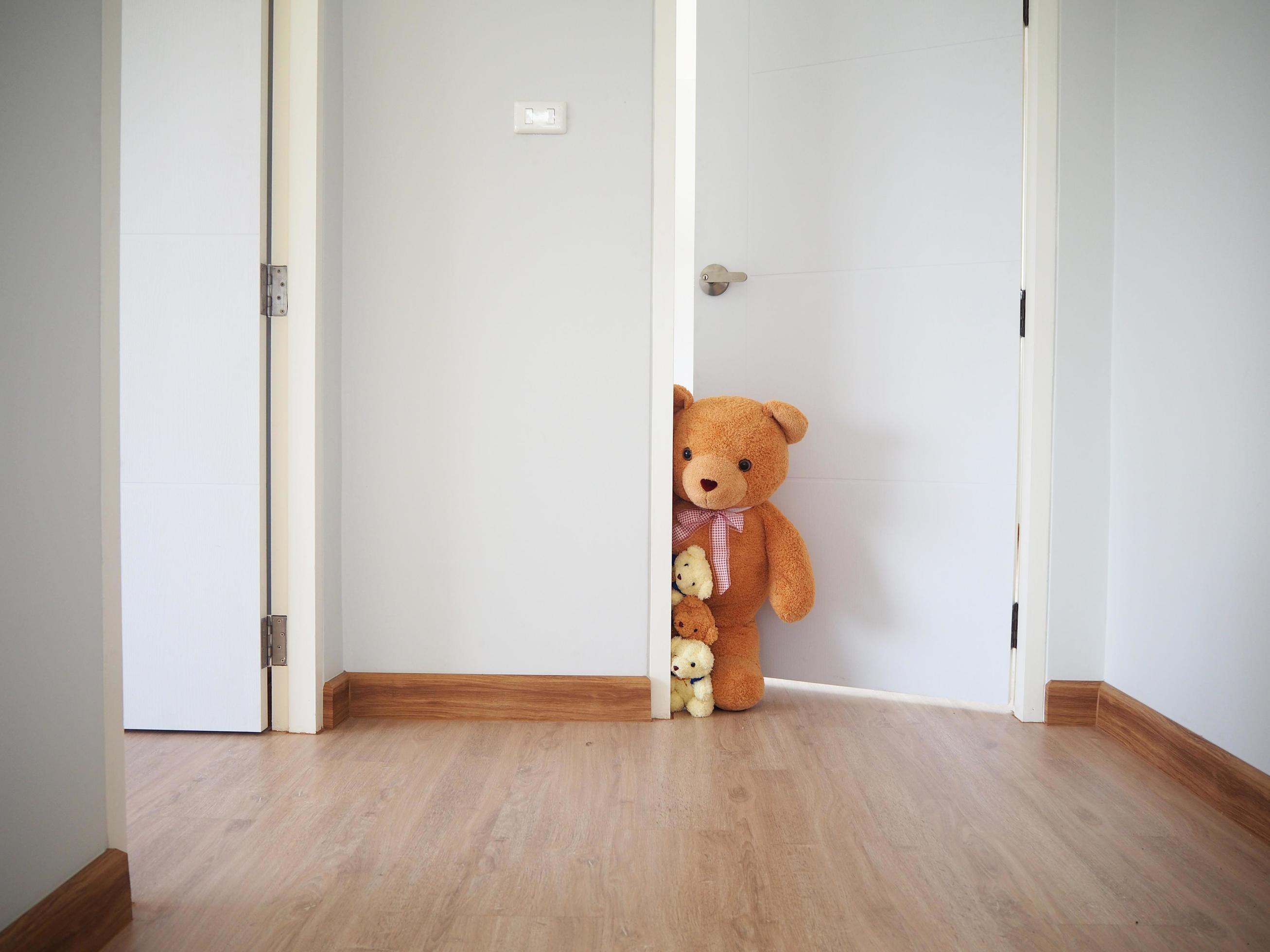 Inside home. The teddy bear family opened the door behind the wall and peeked some. Stock Free