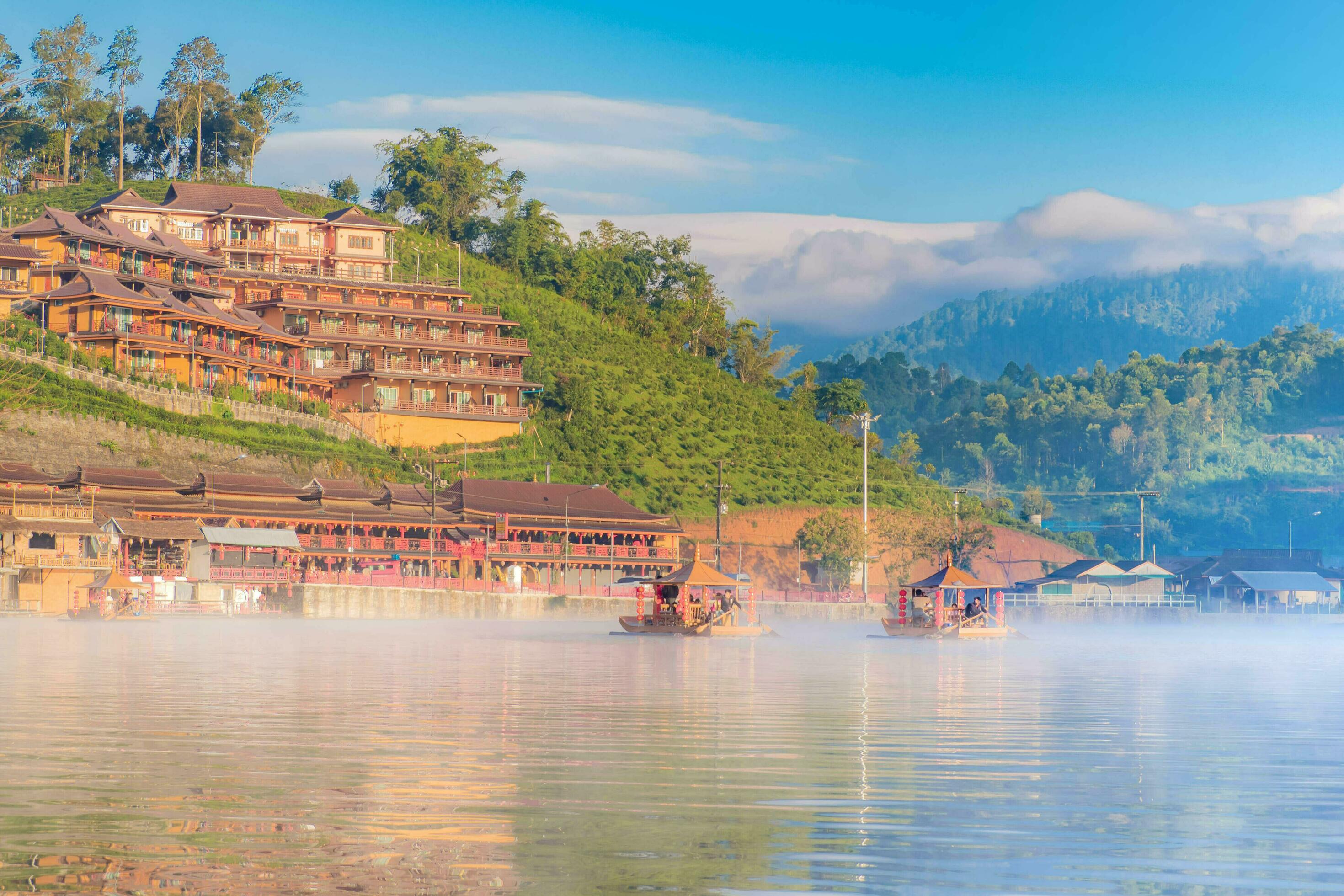 Chinese boat launched early in the morning at Rak Thai hamlet in Maehongson, Thailand, on the lake with water vapor, Banrakthai, Ban rak thai. Stock Free