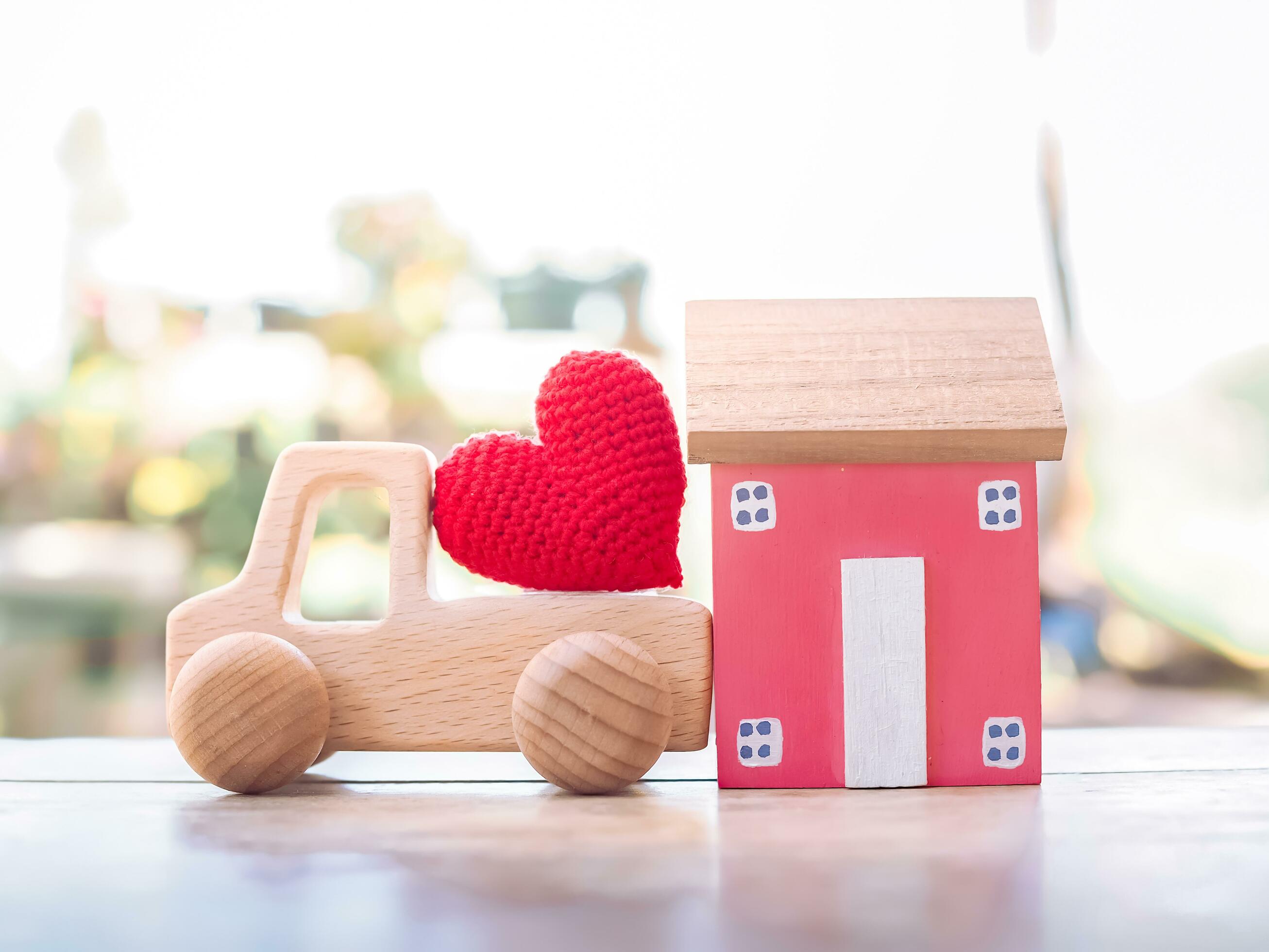 Miniature house, Red heart and wooden toy car. Concept of family Stock Free