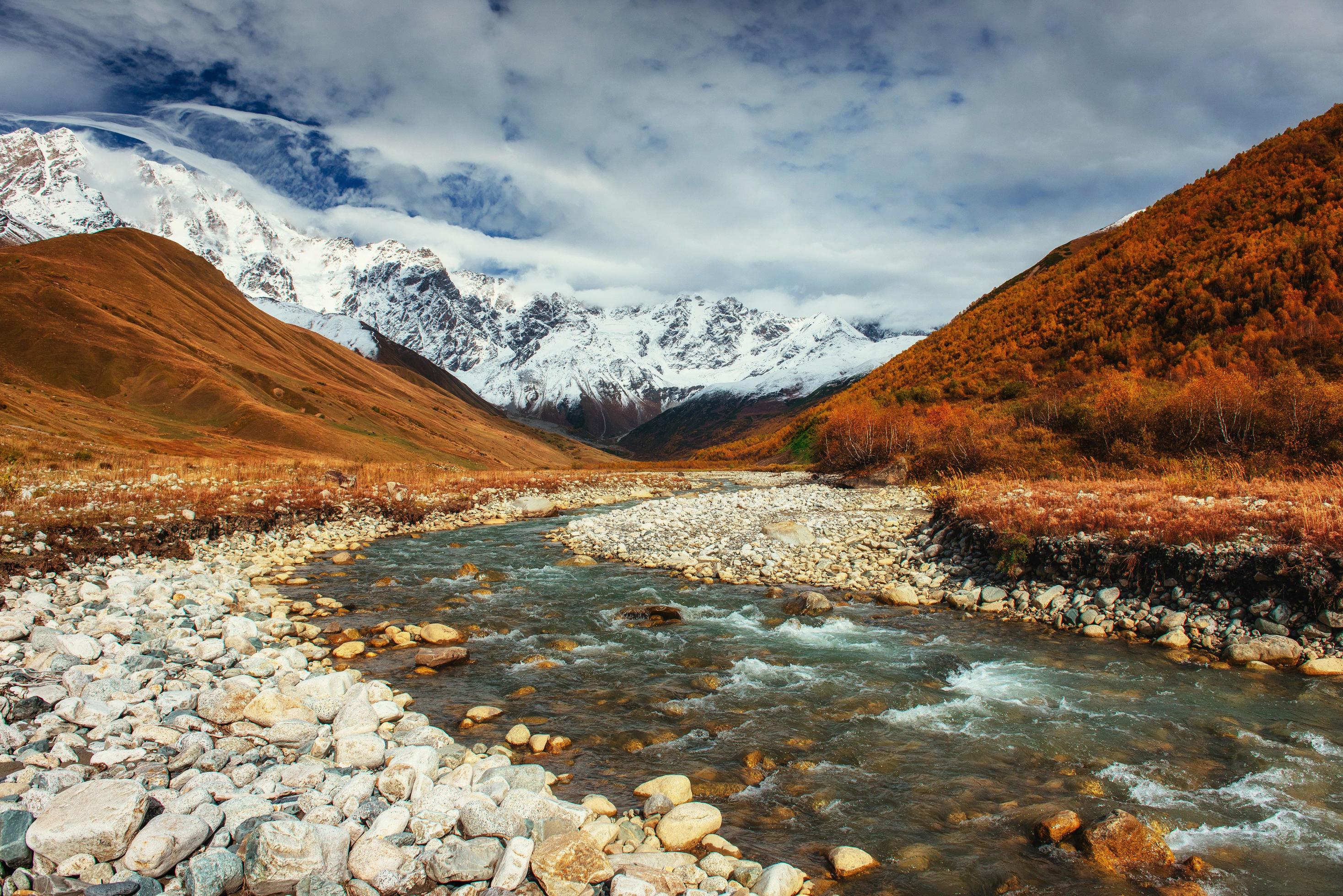 Snowy mountains and noisy mountain river. Georgia, Svaneti Stock Free