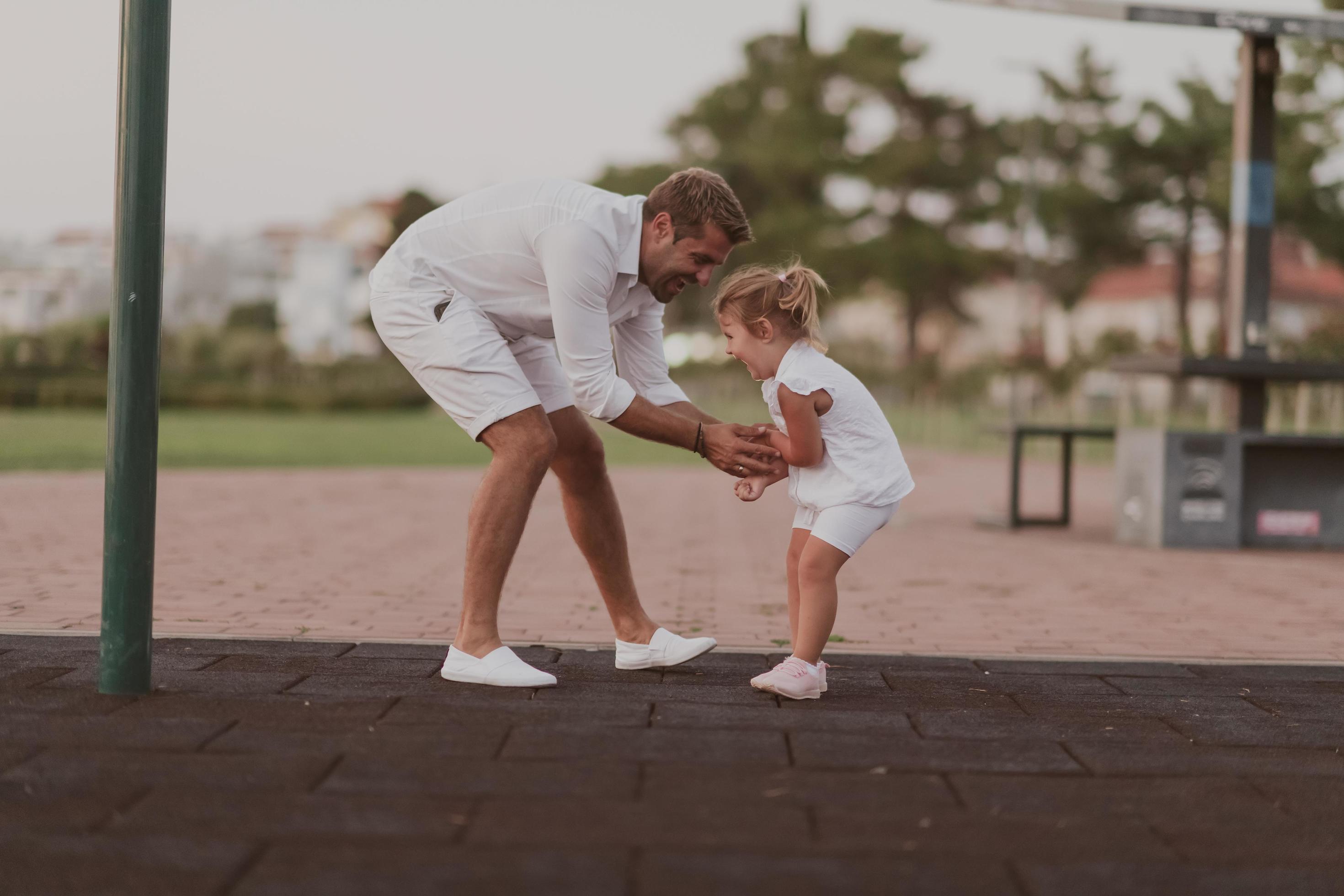 An elderly man in casual clothes with his daughter spends time together in the park on vacation. Family time. Selective focus Stock Free